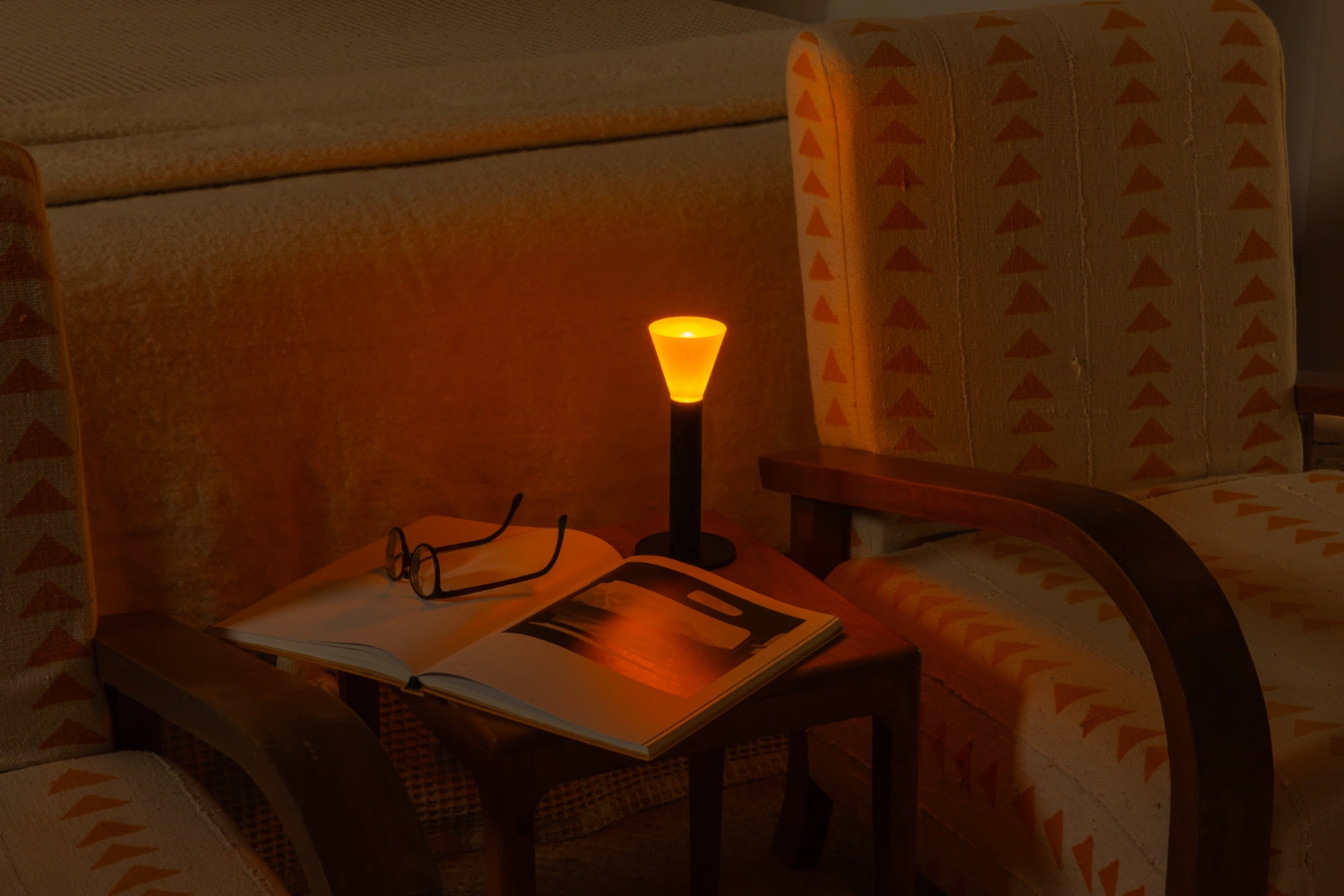 Halo Mag (Flame + Bloom) designed by Mandalaki — A sculptural lamp intervention positioned within a domestic seating arrangement, the Halo Flame edition commands attention through its minimal formal language.