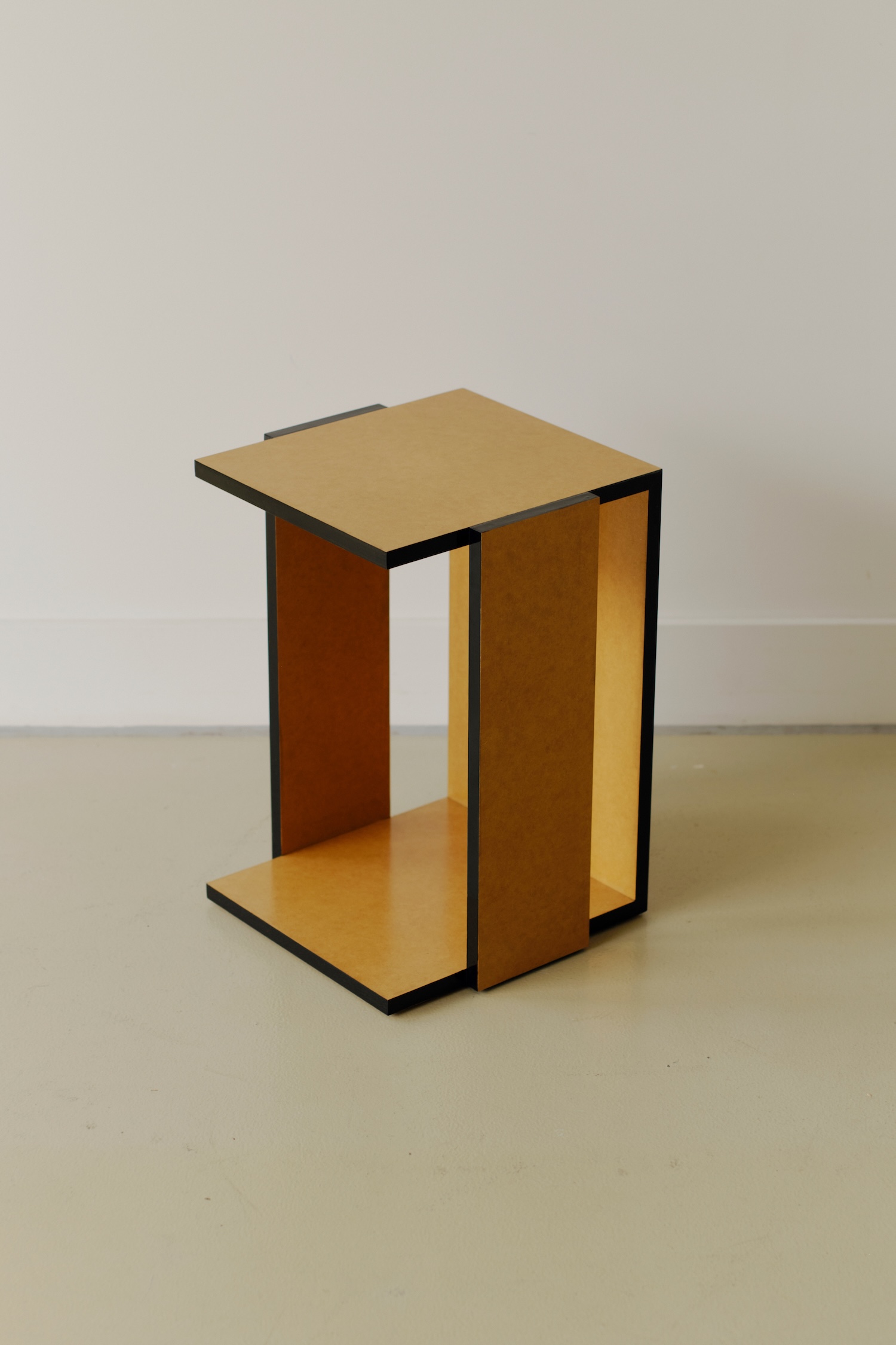 Undressed Collection by Georgina Davies — A cubic side table from Davies's Undressed Collection reveals its internal structural logic through negative void spaces.