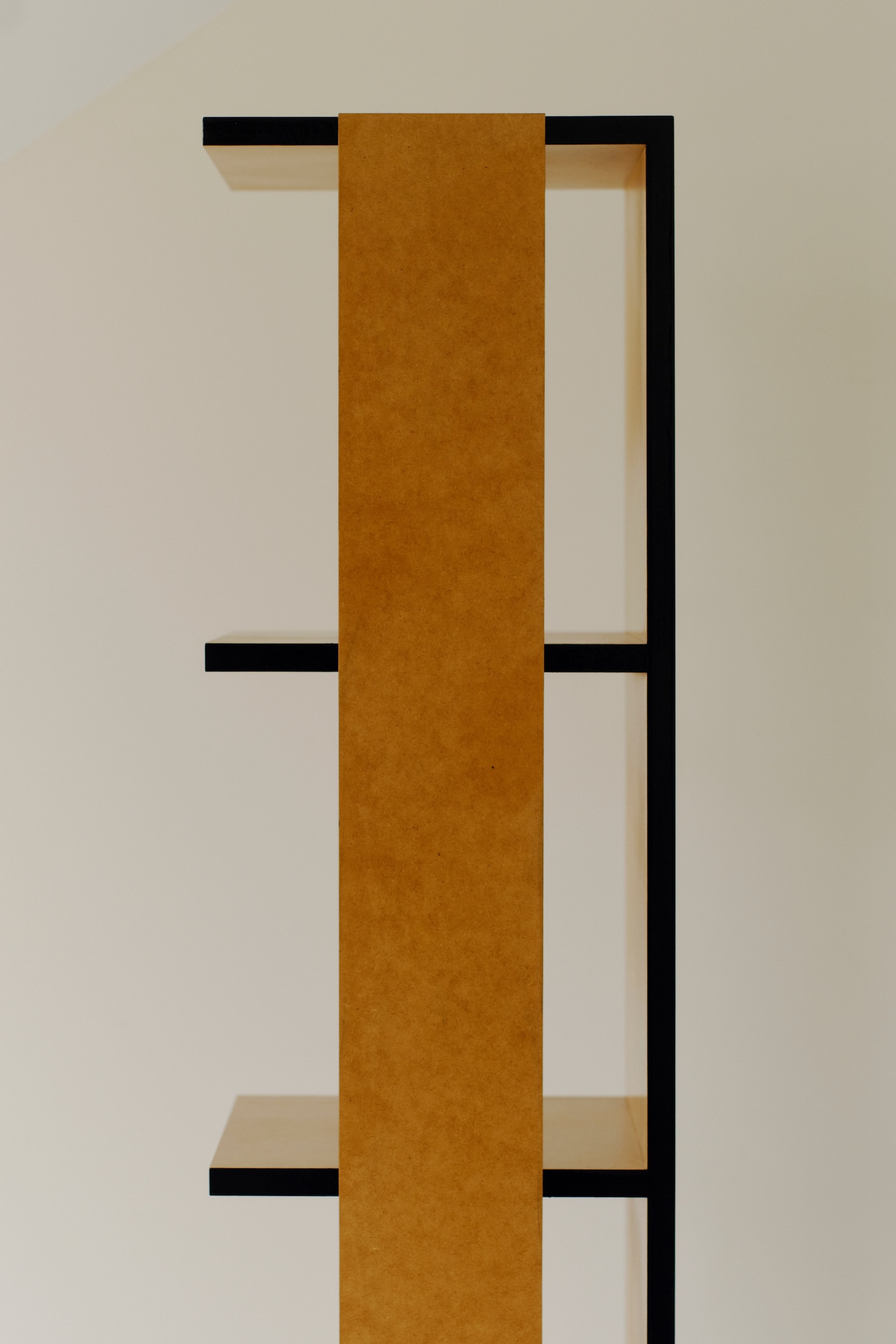 Undressed Collection by Georgina Davies — A tall vertical shelving unit from Georgina Davies' Undressed Collection showcases raw MDF materiality as primary design element.