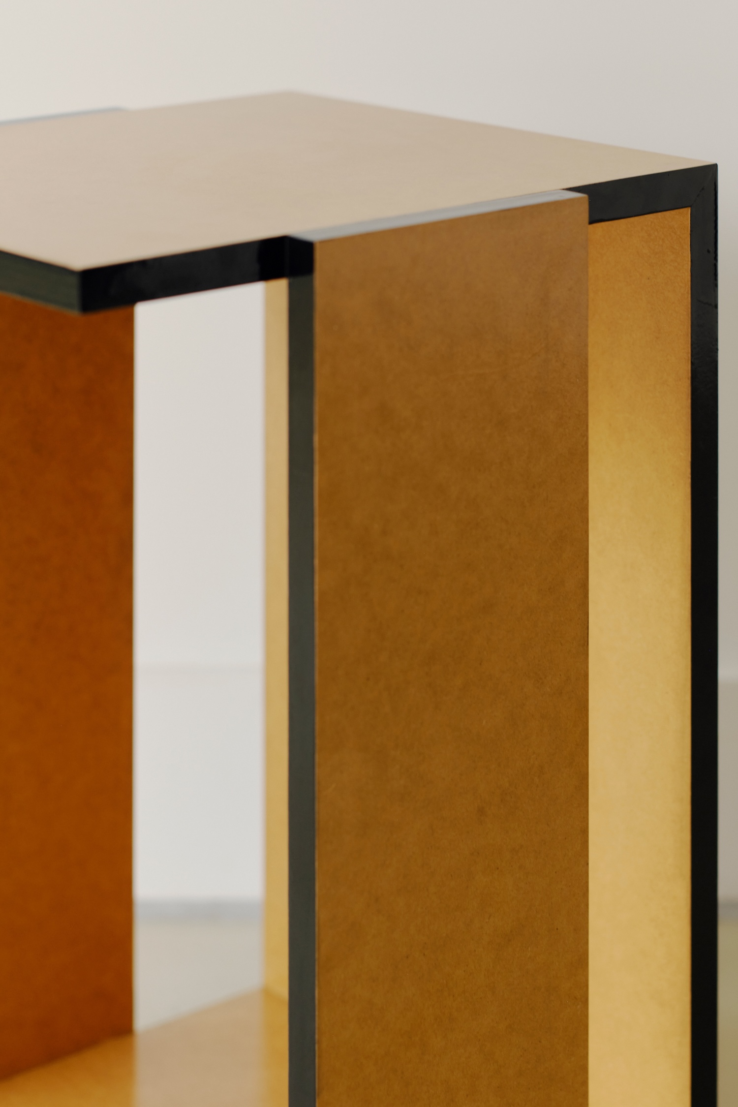 Undressed Collection by Georgina Davies — A console table from the Undressed Collection featuring vertically stacked MDF boards with fully exposed edges and seams, creating a rhythmic linear texture...