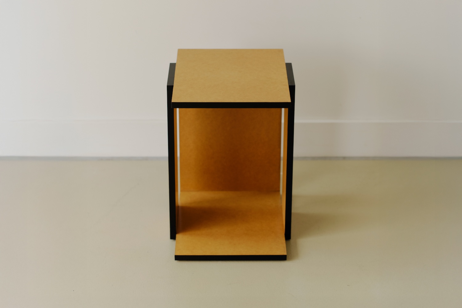 Undressed Collection by Georgina Davies — A cubic storage unit from Davies' Undressed Collection presents MDF as primary material, its warm ochre surfaces left unfinished to reveal grain and edge seams.