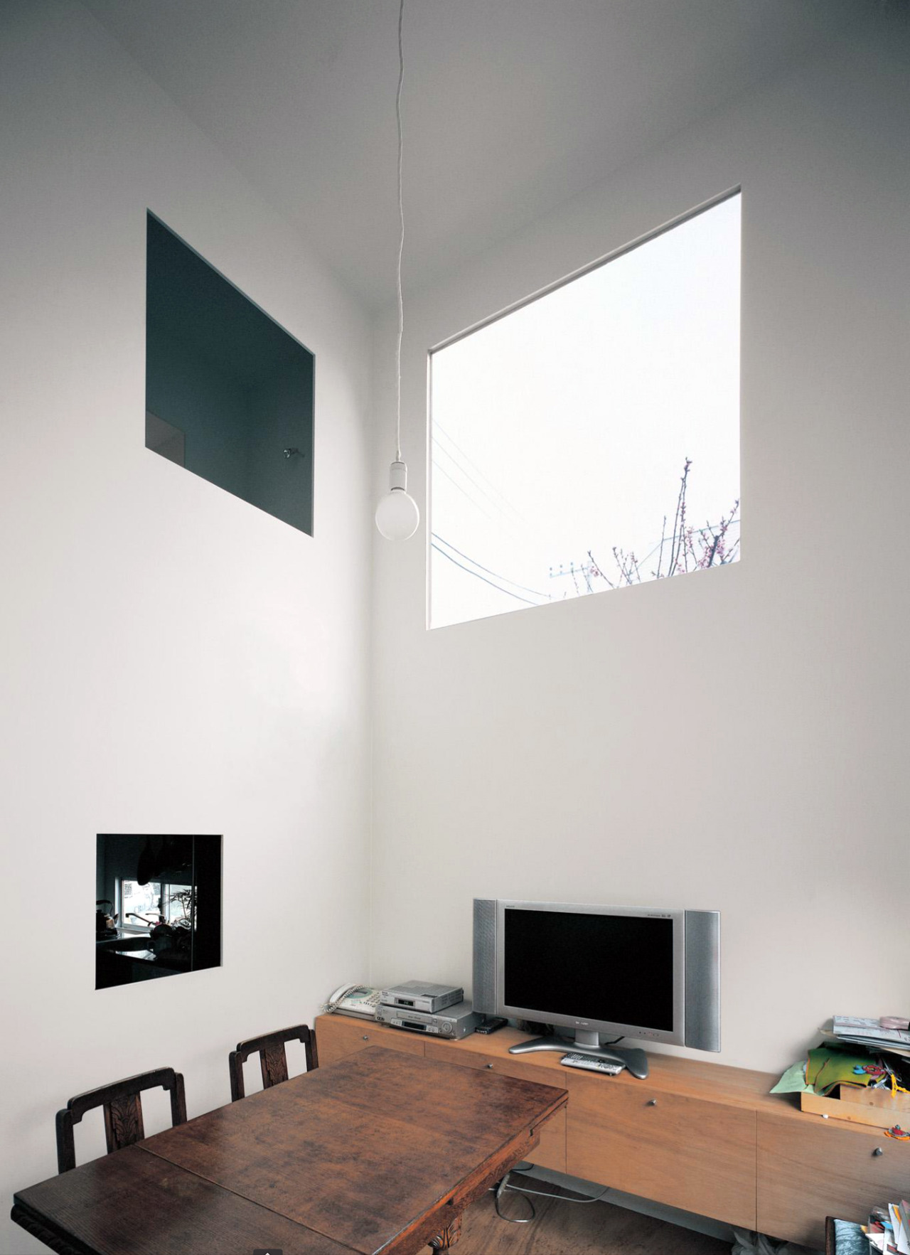 House in a Plum Grove by Kazuyo Sejima by Kazuyo Sejima & Associates — Interior workspace at the corner of the House in a Plum Grove, where Sejima's vertical intervention creates a lived domestic environment.