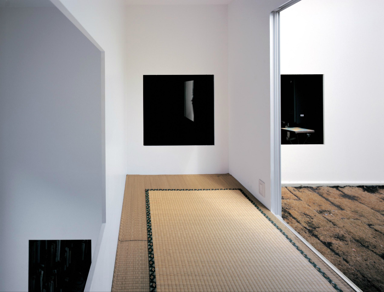 House in a Plum Grove by Kazuyo Sejima by Kazuyo Sejima & Associates — Interior corridor of woven tatami matting bordered by dark geometric trim, viewed along the length of the narrow passage.