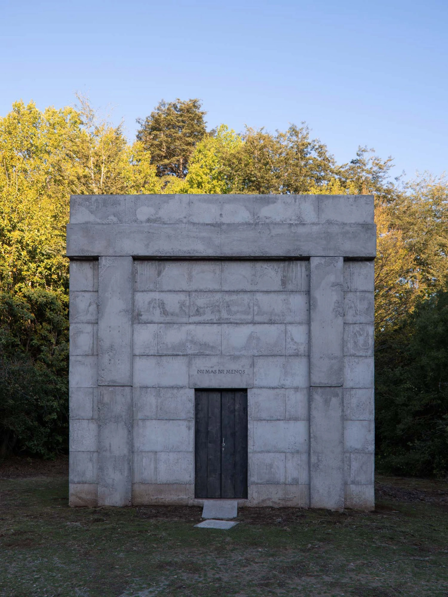 MIEL Pavilion by Pezo von Ellrichshausen — The MIEL Pavilion presents itself as a monolithic concrete volume set against a dense woodland backdrop.