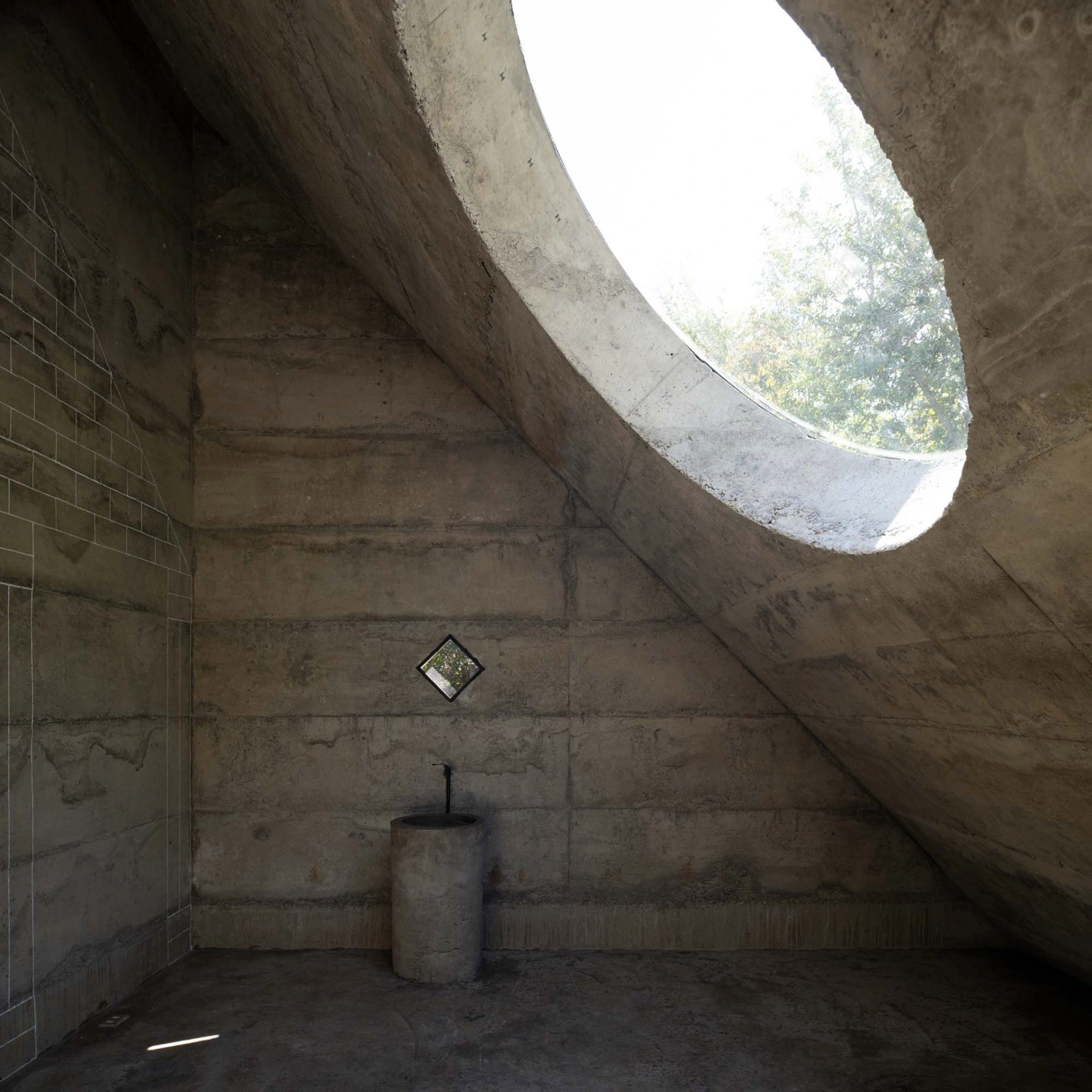 MIEL Pavilion by Pezo von Ellrichshausen — Interior view of MIEL Pavilion capturing the dramatic interplay of concrete surfaces and natural illumination.