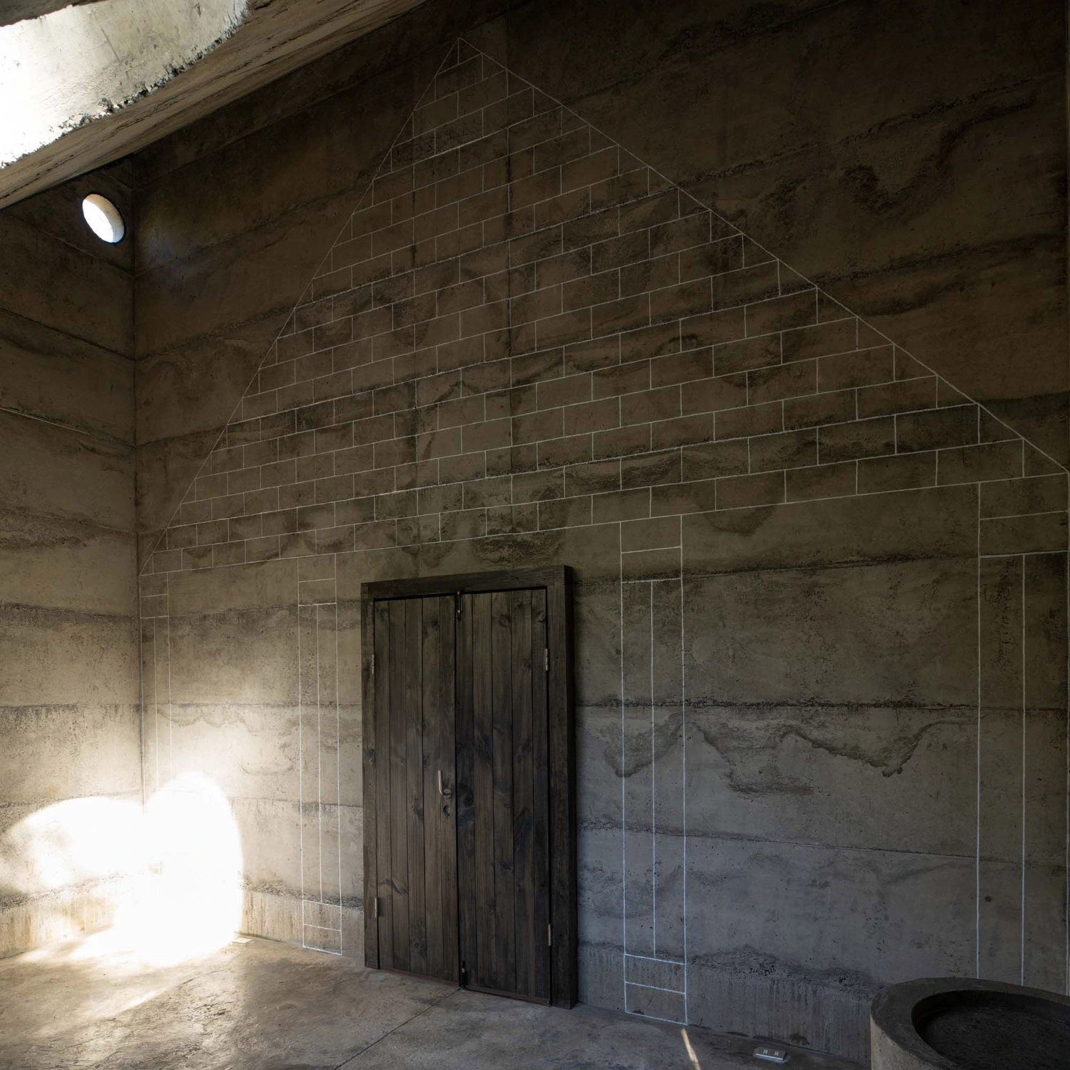 MIEL Pavilion by Pezo von Ellrichshausen — A concrete interior defined by diagonal geometry and controlled natural light.