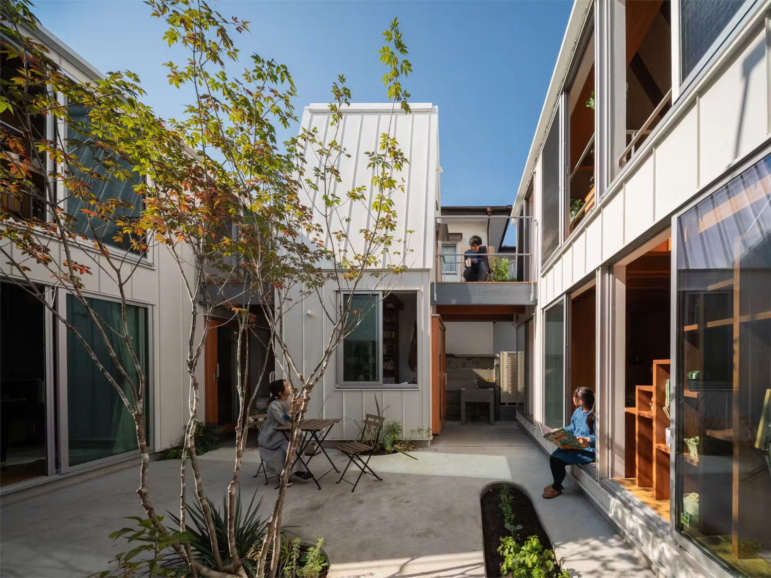 Little Village by Takeshi Hosaka — Little Village's central courtyard reveals the project's dispersed volumetric strategy through a single vantage point.