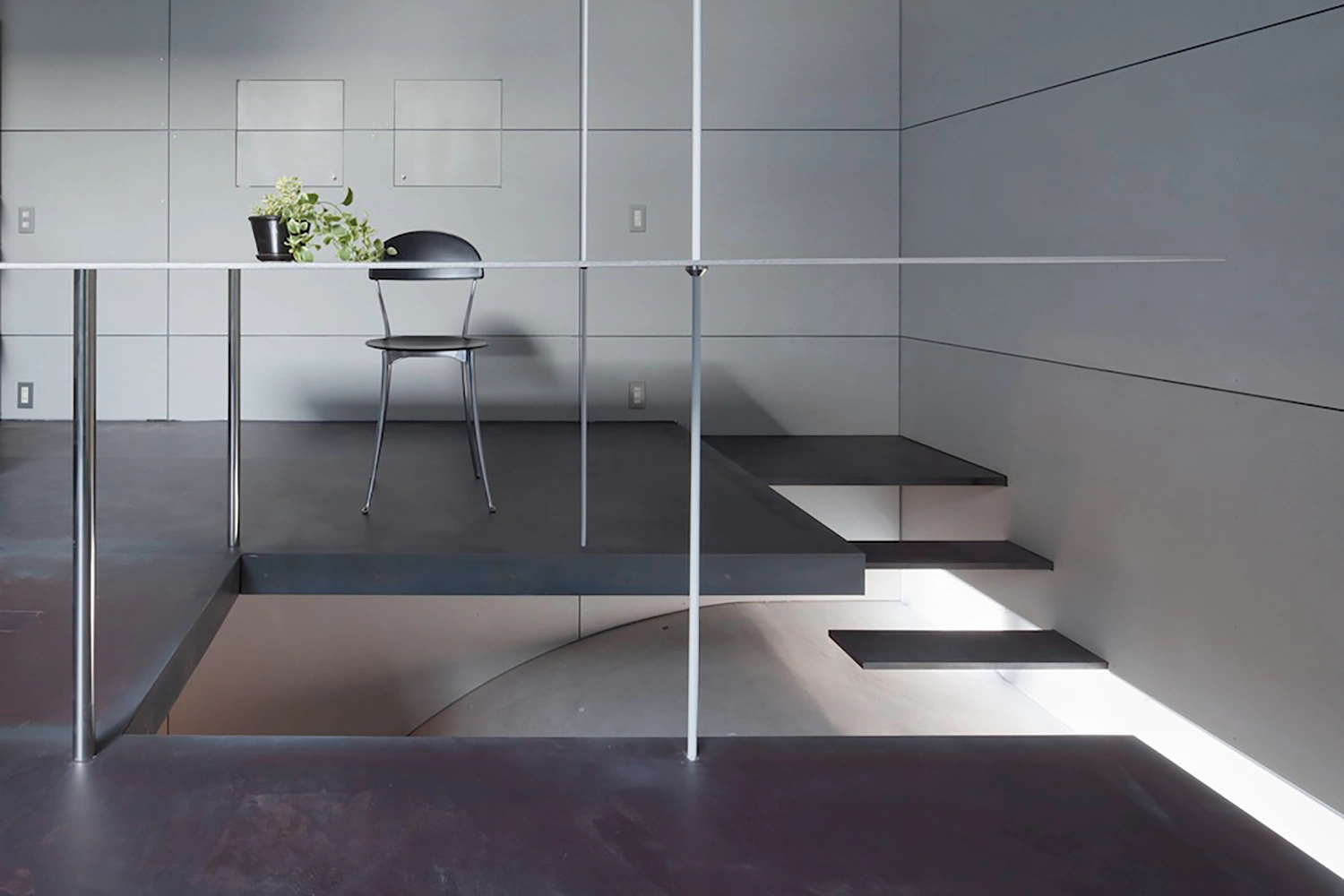 Tunnel House by Makiko Tsukada Architects — Interior view of the Tunnel House revealing the quarter-cylinder void carved through the structure.