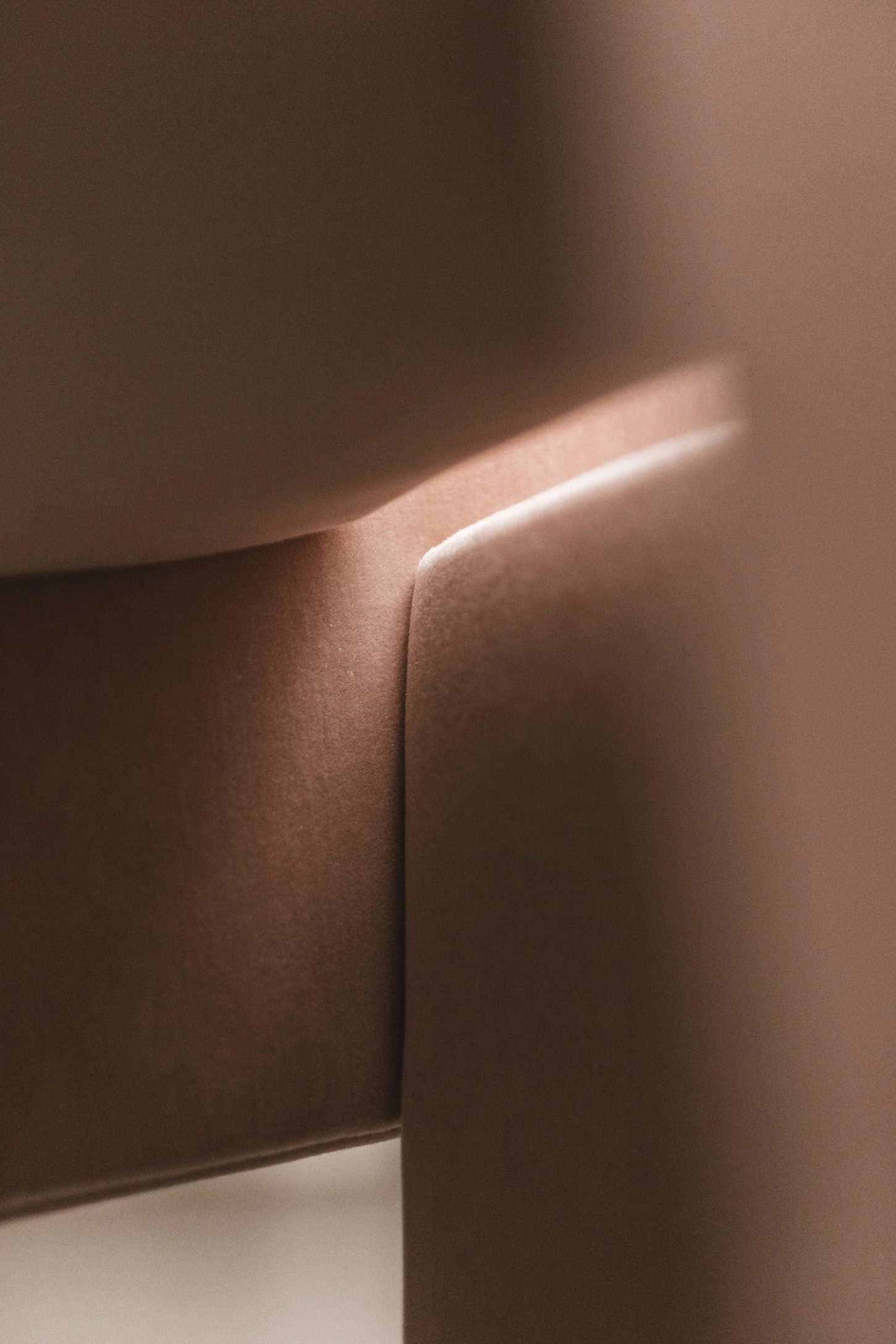 Cubist Chair by ÆTHER/MASS — Close-up detail of upholstered chair showing soft-edged geometric planes in terracotta and cream fabric.