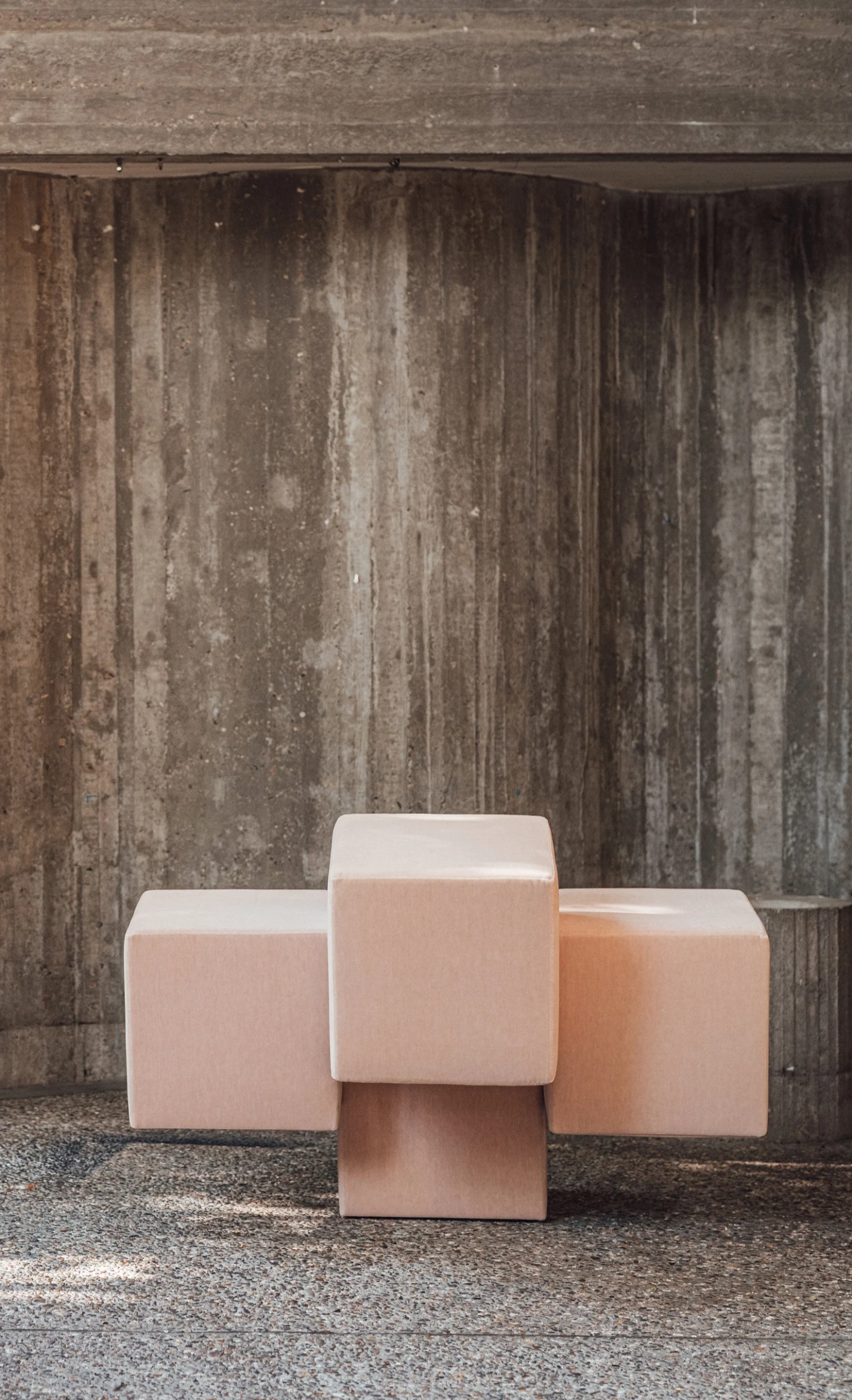 Cubist Chair by ÆTHER/MASS — Three cubic upholstered seating objects arranged in loose triangular composition against a weathered timber backdrop.