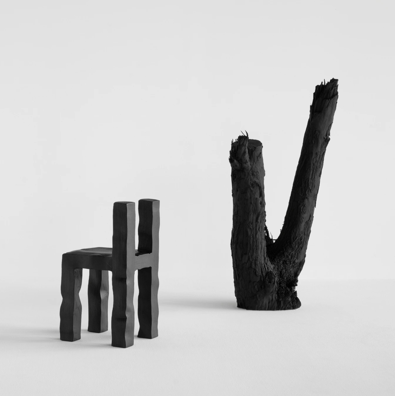 KAMEH 0.5 Collection by KAMEH — Two sculptural objects rendered in charred timber sit against a neutral backdrop.