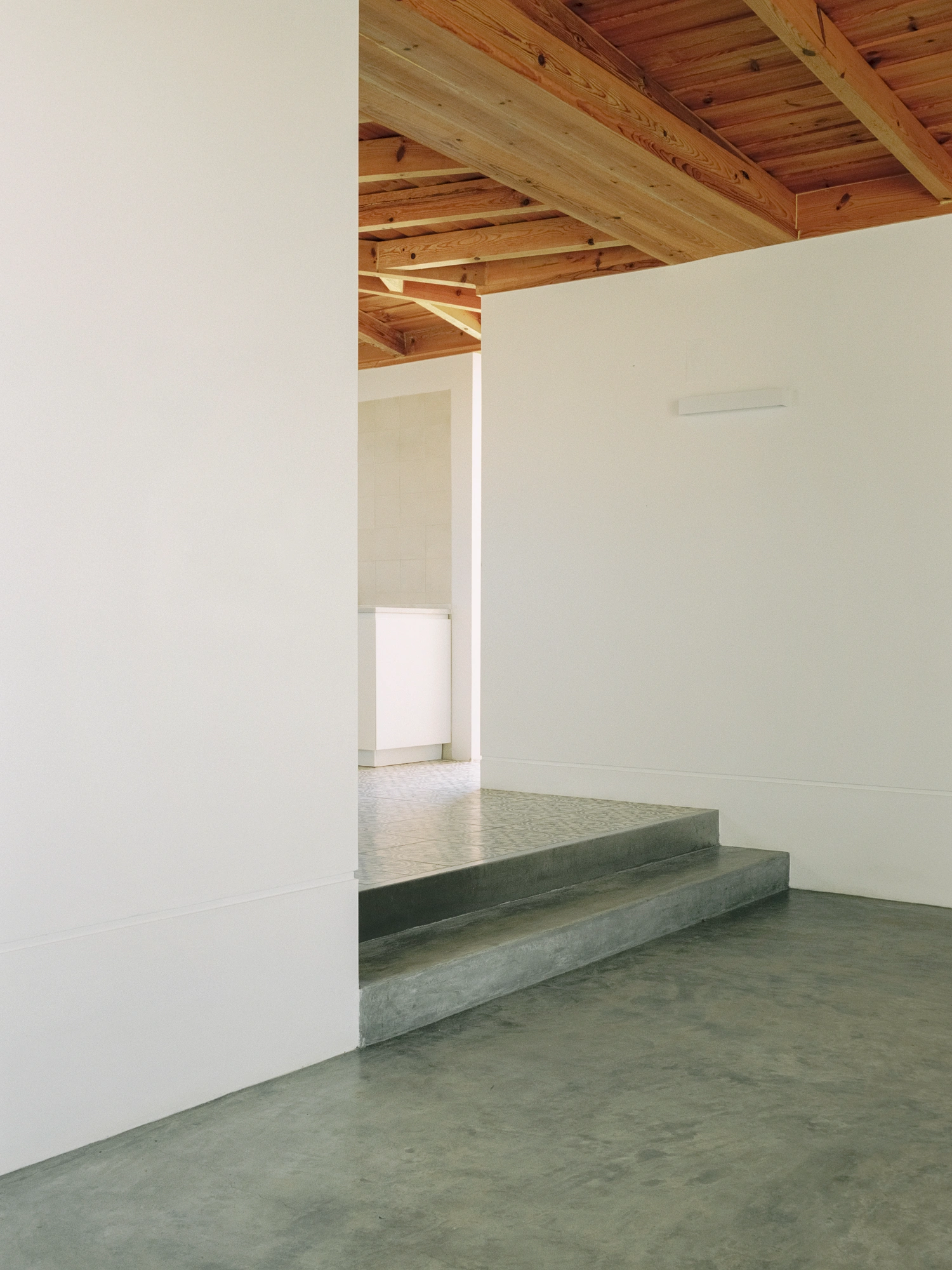 Herdade da Cardeira Winery by EMBAIXADA by EMBAIXADA arquitectura — Interior threshold of the winery reveals the material hierarchy that defines the project.