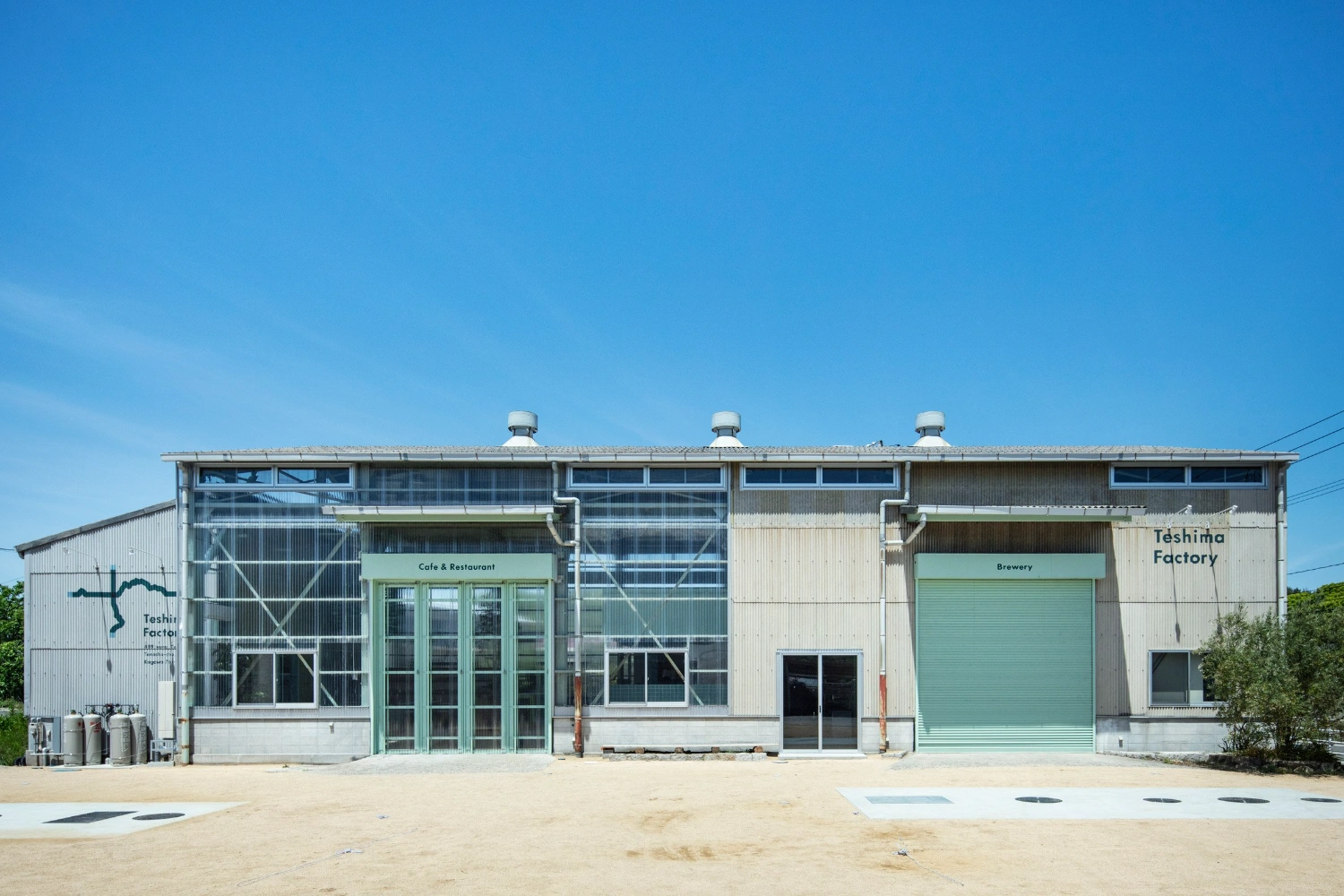 Teshima Factory Cafe by Schemata Architects — The Teshima Factory Cafe presents a bifurcated facade addressing its dual function.