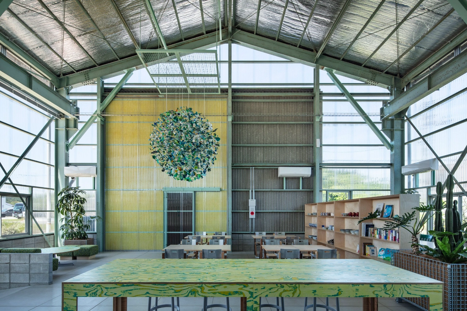 Teshima Factory Cafe by Schemata Architects — A capacious industrial volume bathed in diffused zenithal light from corrugated polycarbonate roof panels.