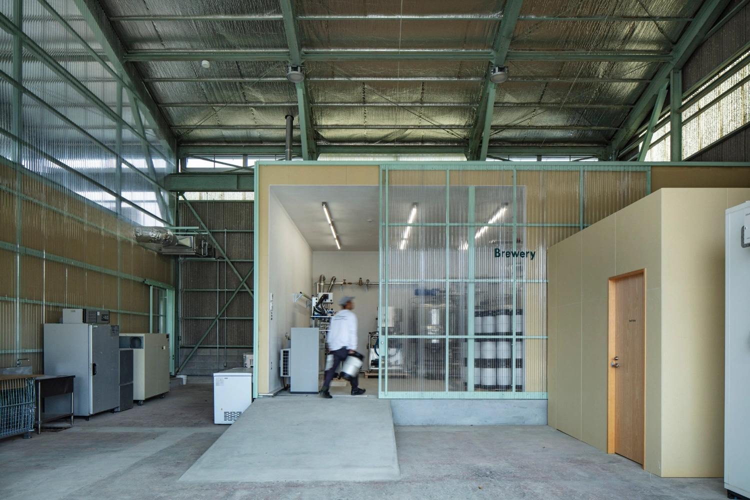 Teshima Factory Cafe by Schemata Architects — The Brewery enclosure demonstrates a functional partitioning strategy within the industrial shell.