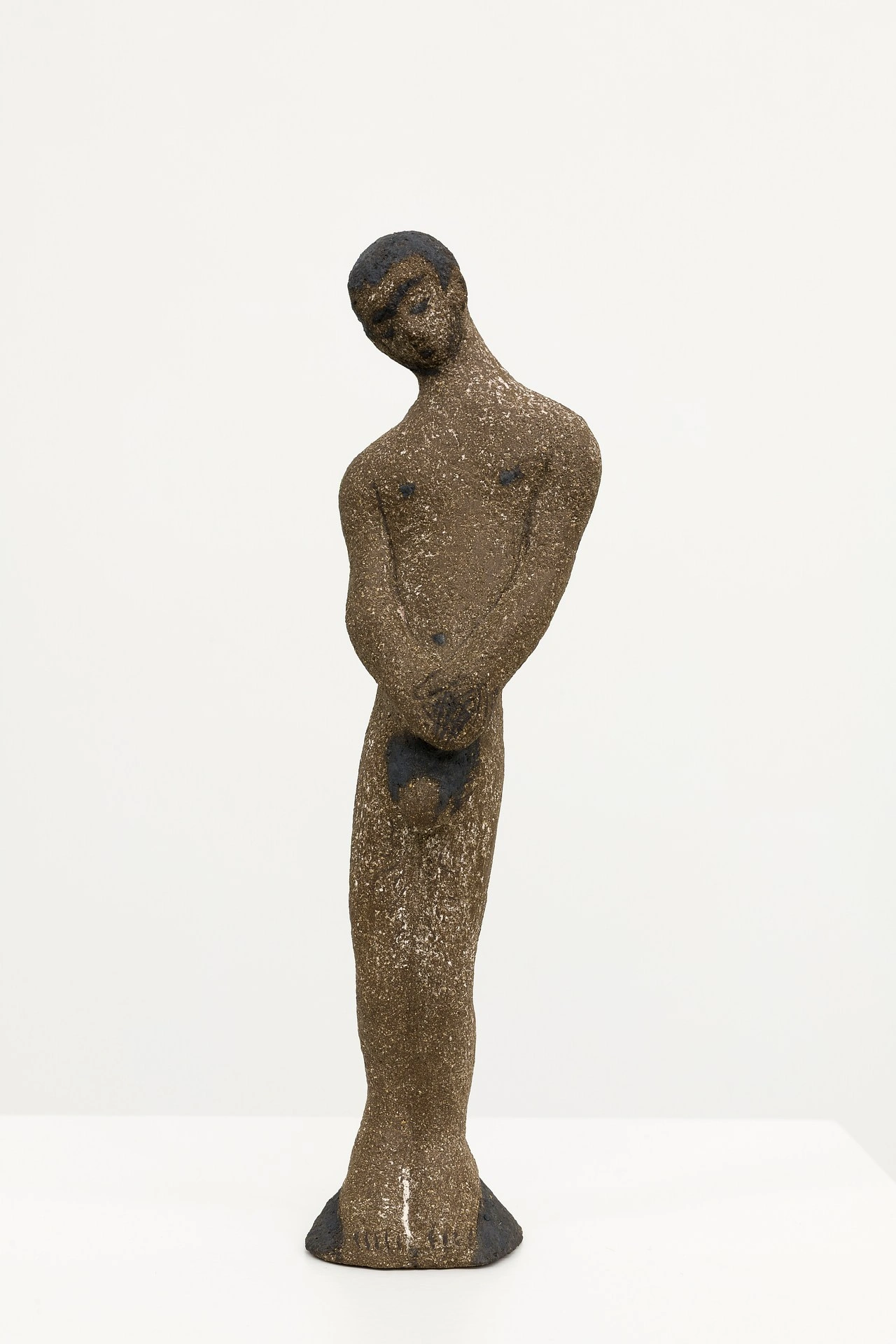La scorza by Louis Fratino at Galerie Neu — A bronze figurative sculpture stands on an elongated tapered base, the patinated surface revealing warm ochre and dark undertones across the modeled form.