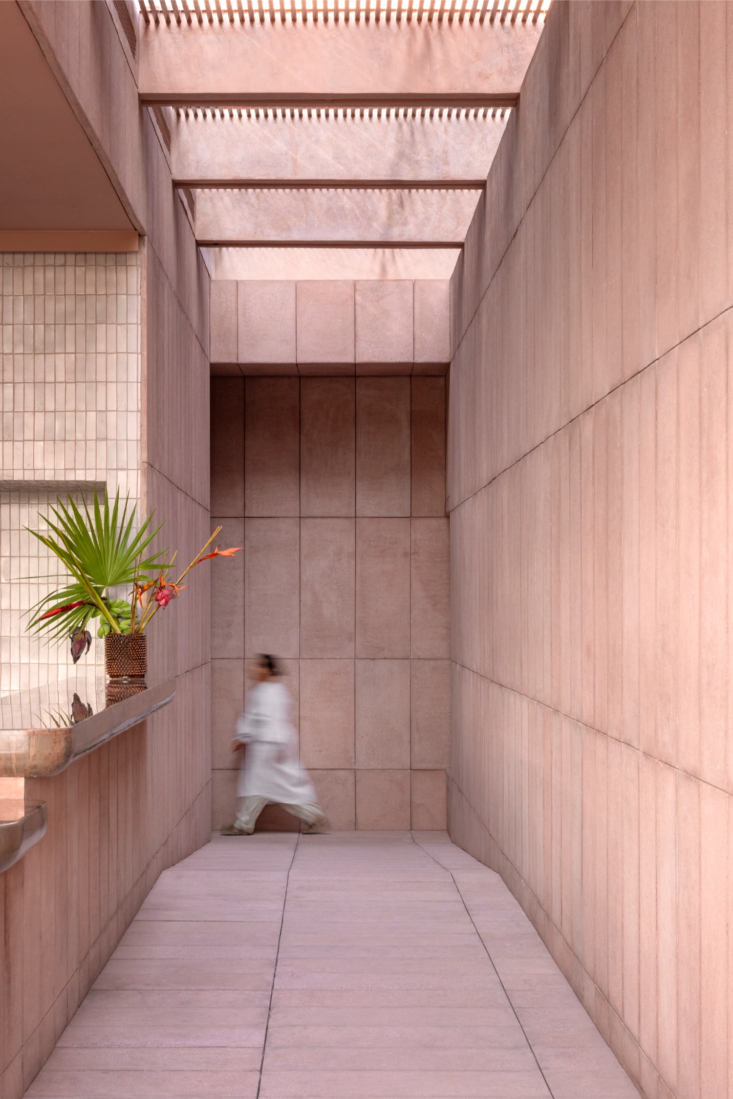Rubra Restaurant by Ignacio Urquiza + Ana Paula de Alba — A narrow passage rendered entirely in mauve-pink ceramic tile creates a linear corridor experience.
