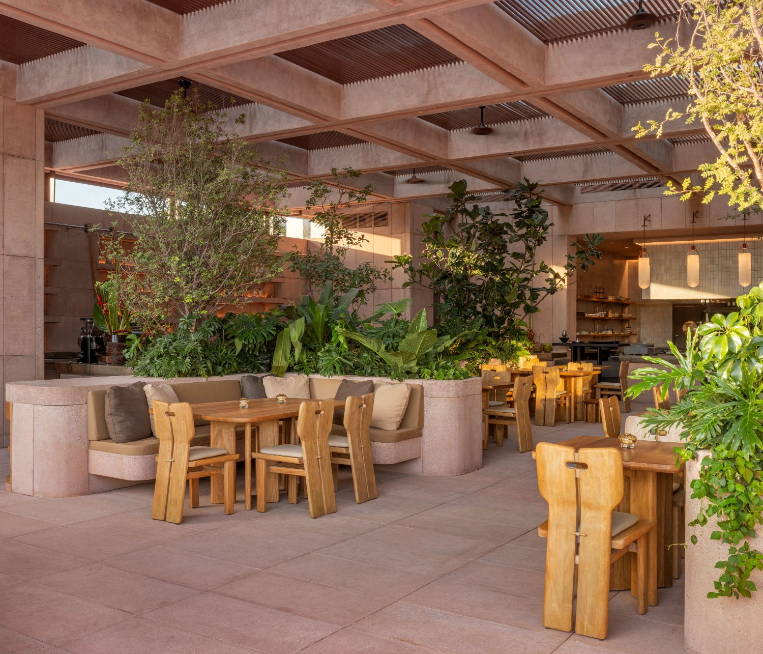 Rubra Restaurant by Ignacio Urquiza + Ana Paula de Alba — The dining terrace showcases a palette of mauve-pink ceramic tiles rendered across structural walls, meeting terracotta-toned floor tiles in a continuous...