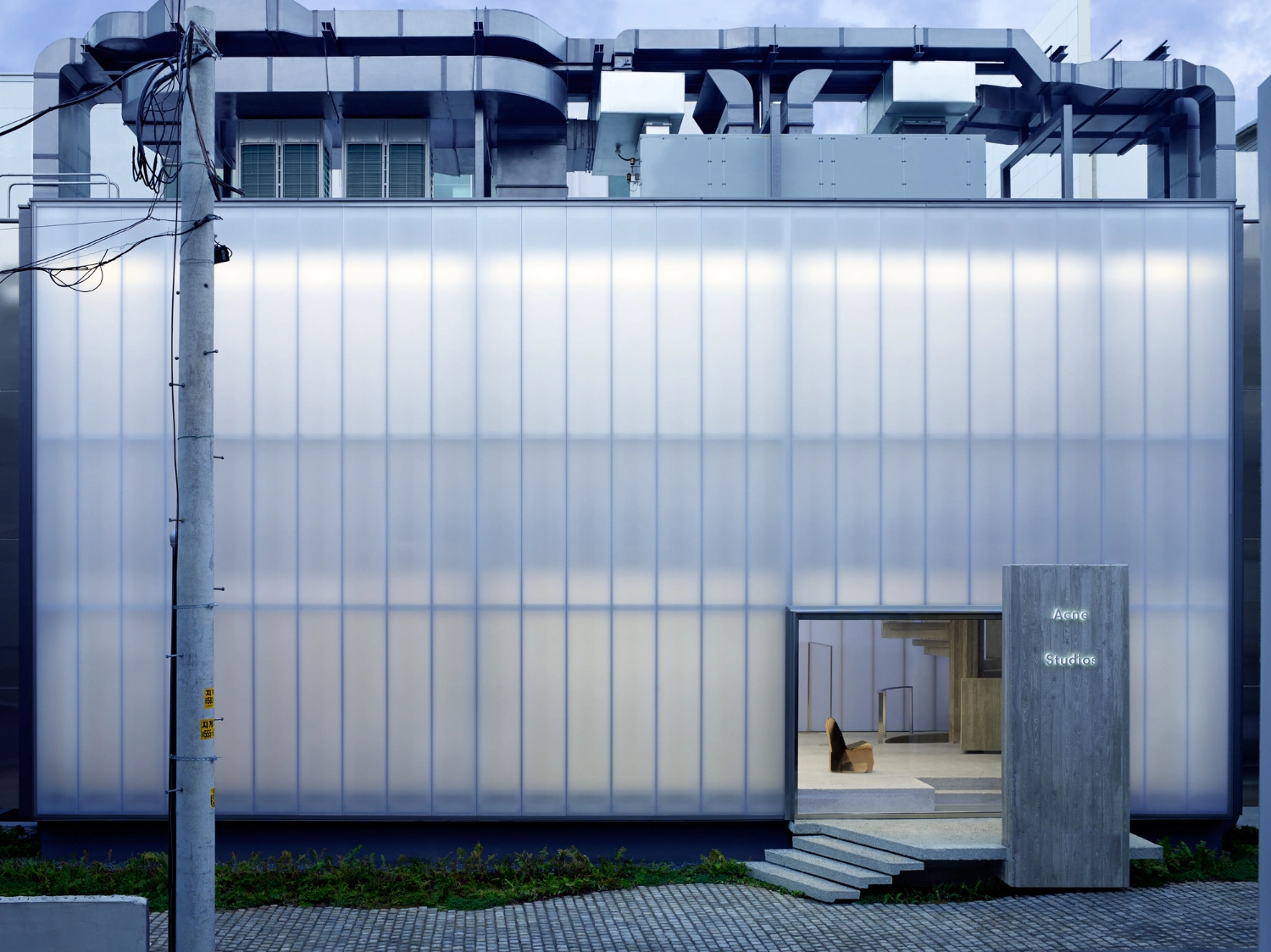 Acne Studios Cheongdam by Sophie Hicks Architects — The Acne Studios Cheongdam storefront presents a stark material contrast across its threshold.