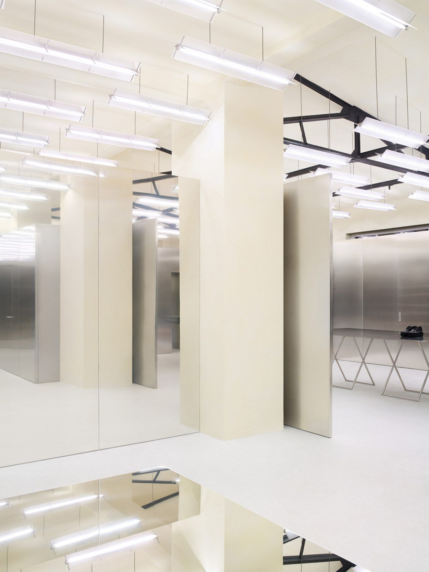 Acne Studios by Bubab Architects — A multi-level retail interior demonstrating spatial transparency through floor-to-ceiling glass partitions.