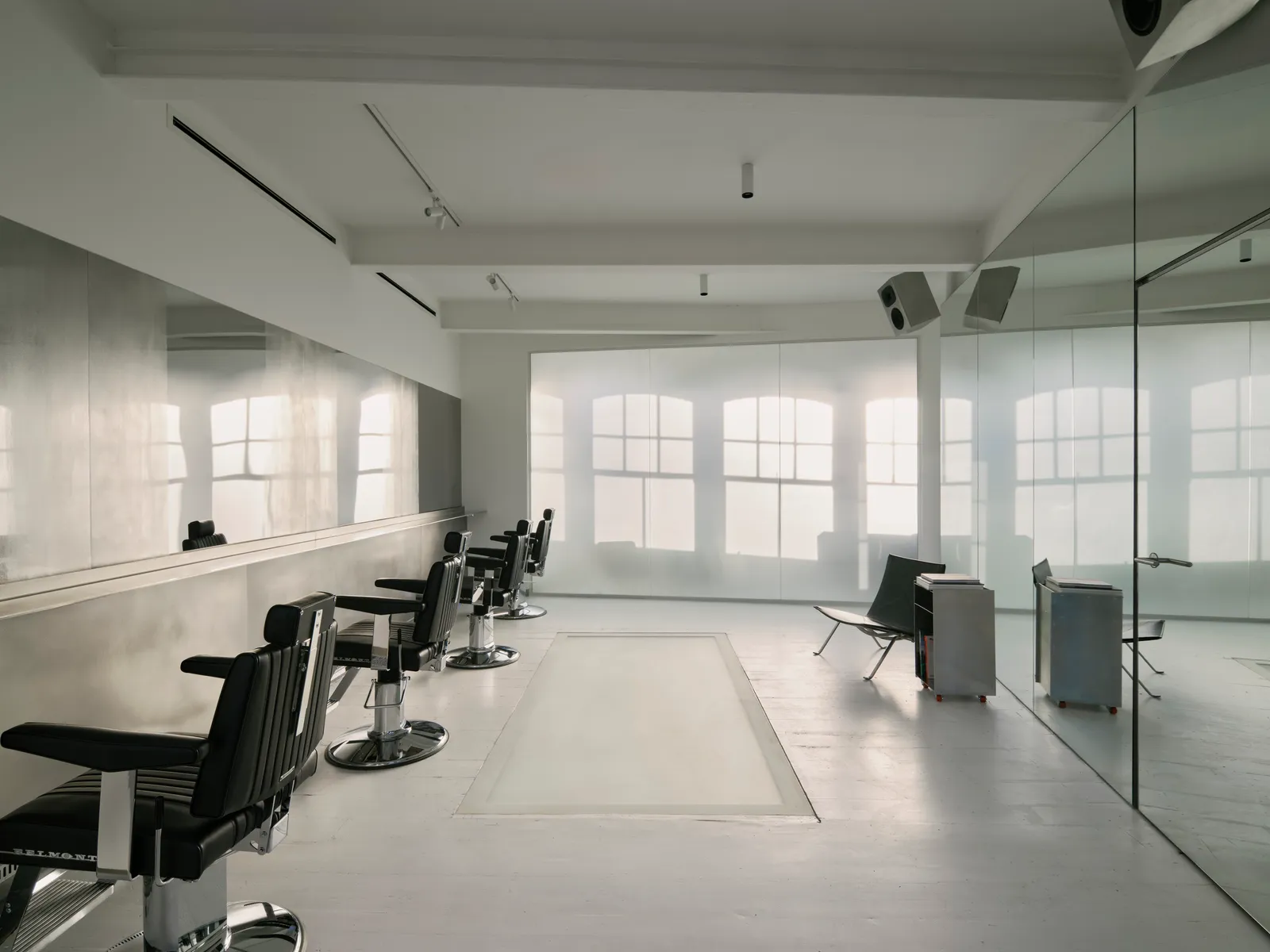Salt Salon by unknown works — A symmetrical salon interior flooded with zenithal light from large arched windows, casting grid-patterned shadows across white ceramic tile flooring.