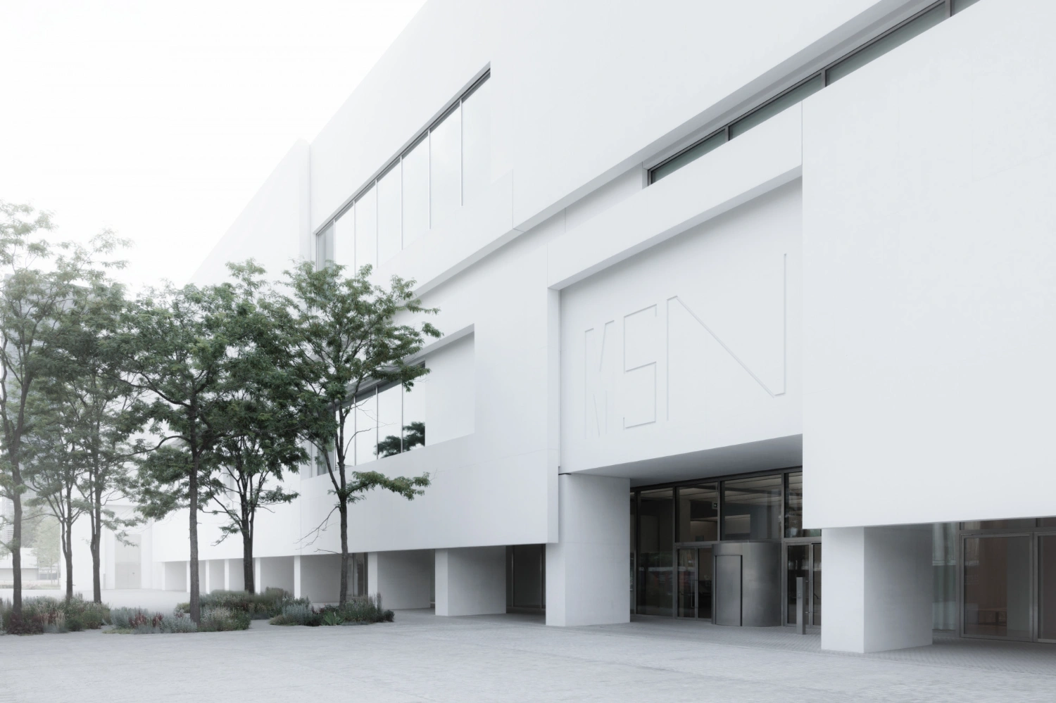 Museum of Modern Art in Warsaw by Thomas Phifer — The Museum of Modern Art's entrance courtyard reveals the building's monolithic concrete presence through stacked horizontal floor plates with recessed...