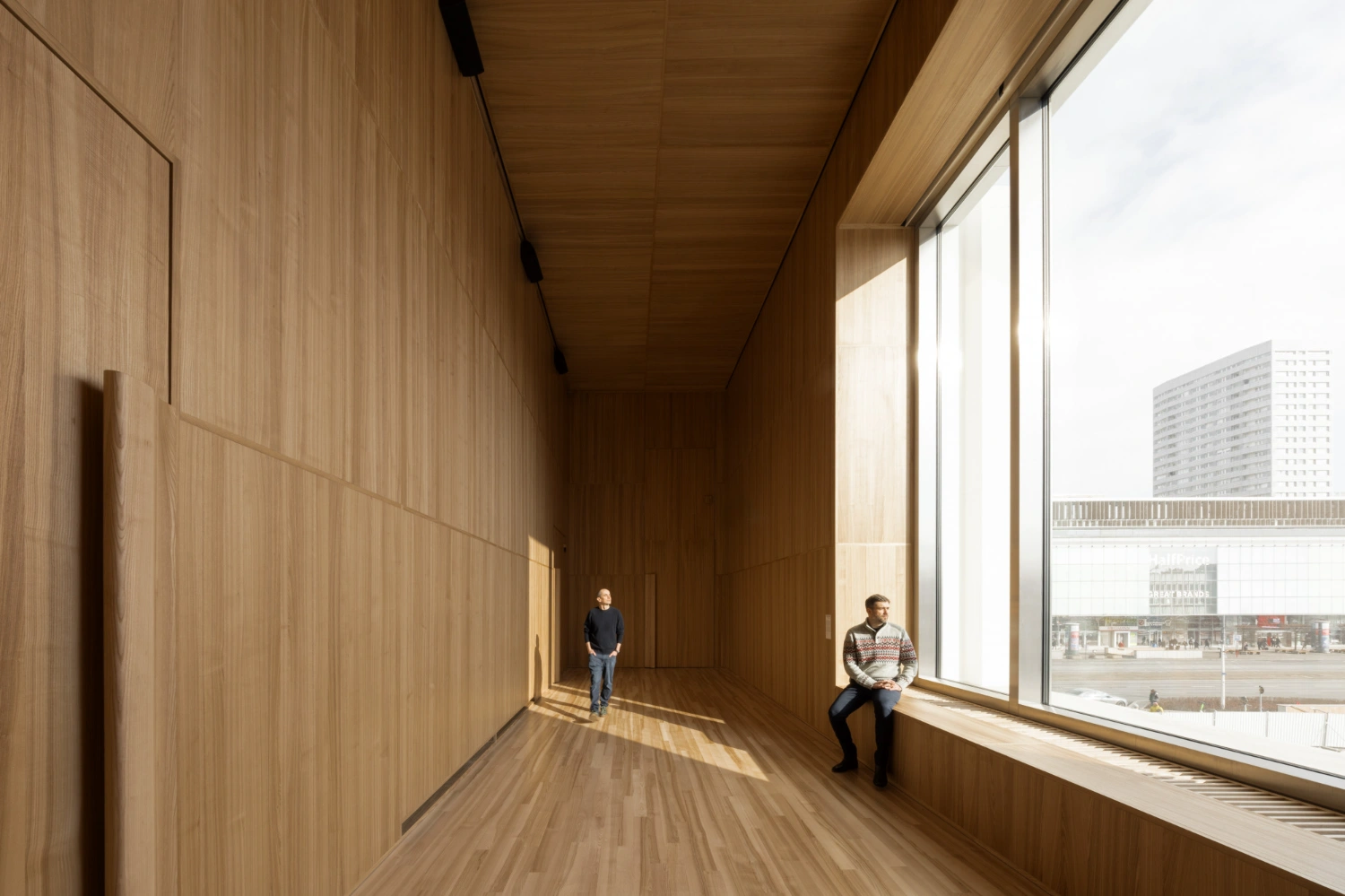 Museum of Modern Art in Warsaw by Thomas Phifer — A corridor clad entirely in light wood paneling—walls, ceiling, and continuous flooring creating a unified, monolithic interior.