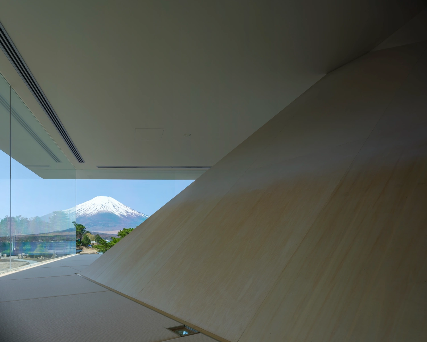 CYCL by YŪ Momoeda Architects — A frameless glazed threshold frames Mount Fuji's snow-capped peak across the Yamanakako landscape.