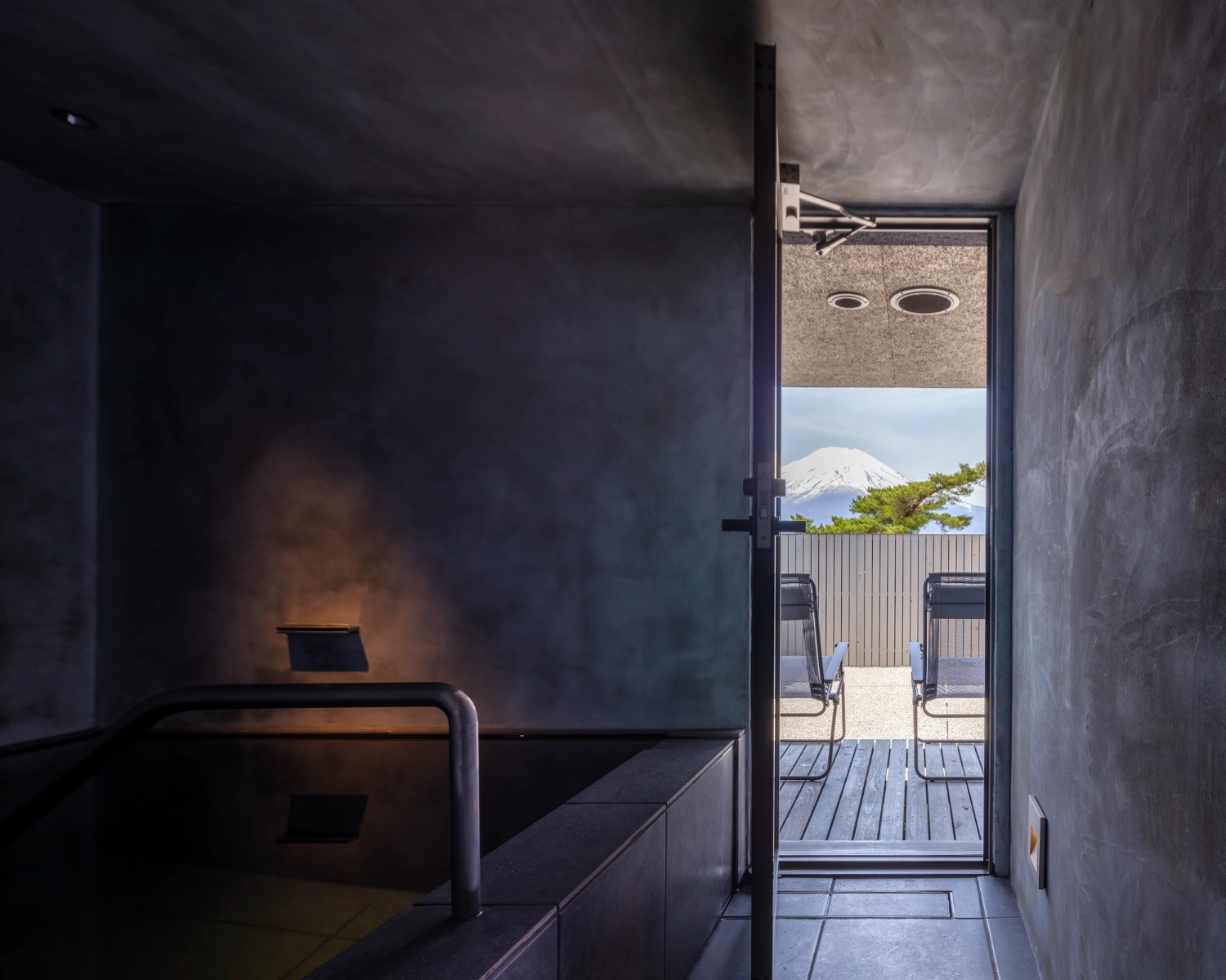 CYCL by YŪ Momoeda Architects — A dark interior corridor frames an expansive view of Mount Fuji across the landscape.