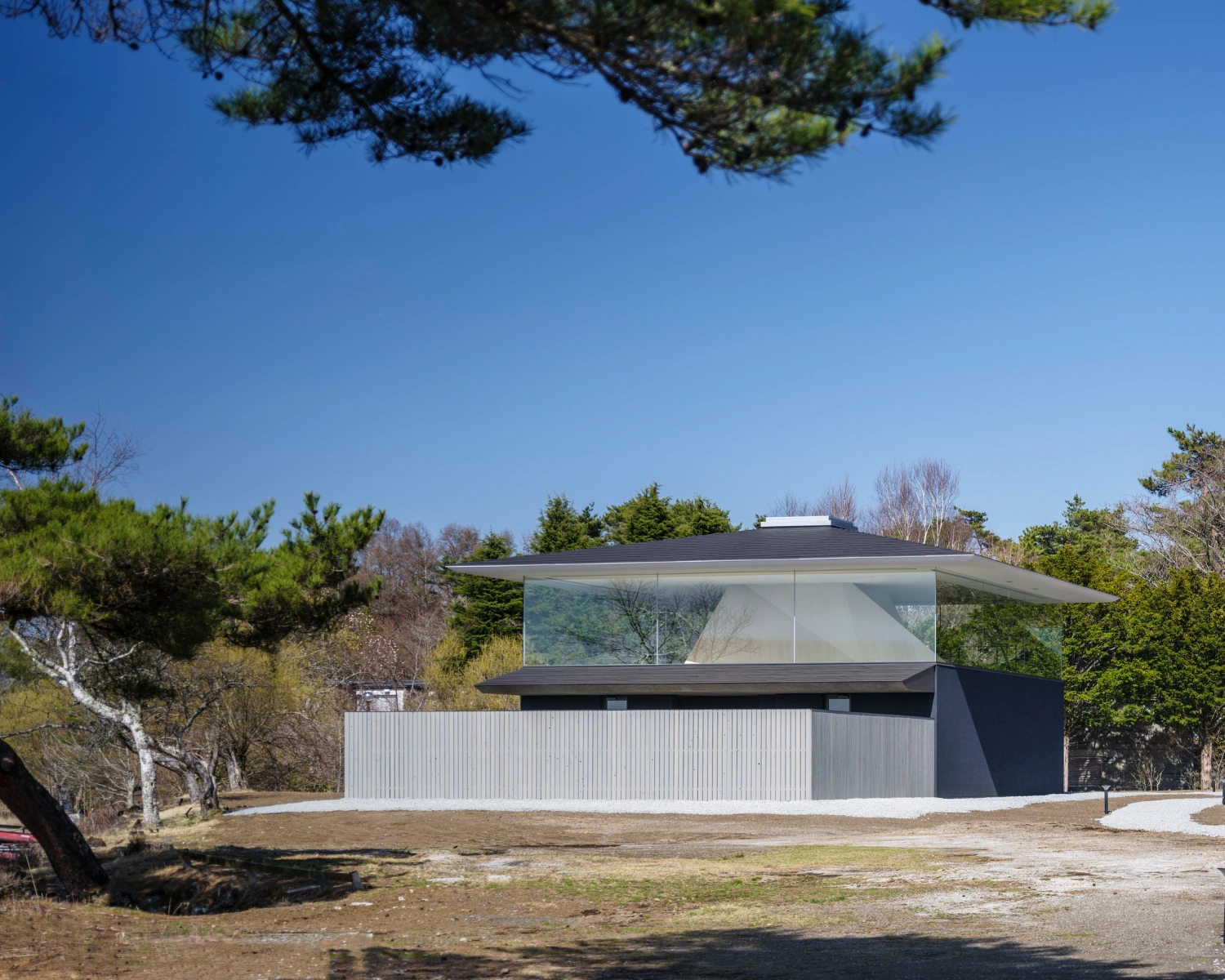 CYCL by YŪ Momoeda Architects — CYCL presents its primary facade as a horizontal volume punctuated by expansive frameless glazing across the upper storey.