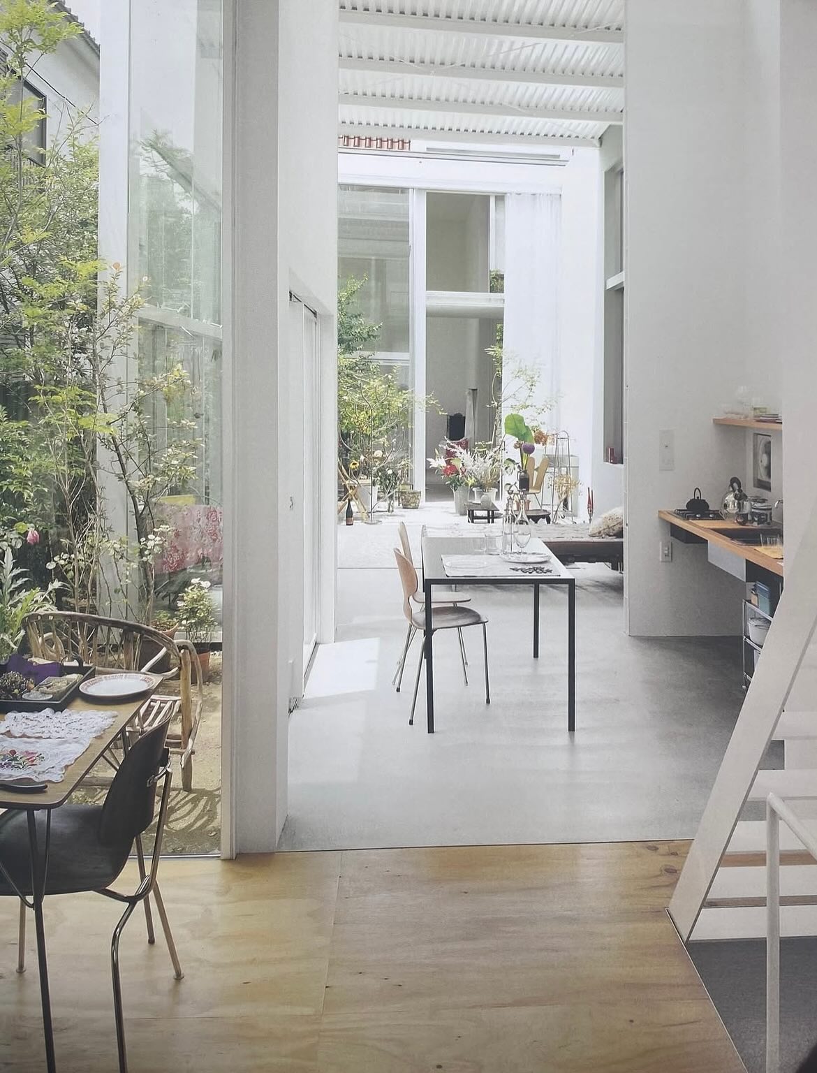 House A by Ryue Nishizawa — A view through House A's interconnected living spaces reveals the architect's strategy of visual continuity across offset volumes.