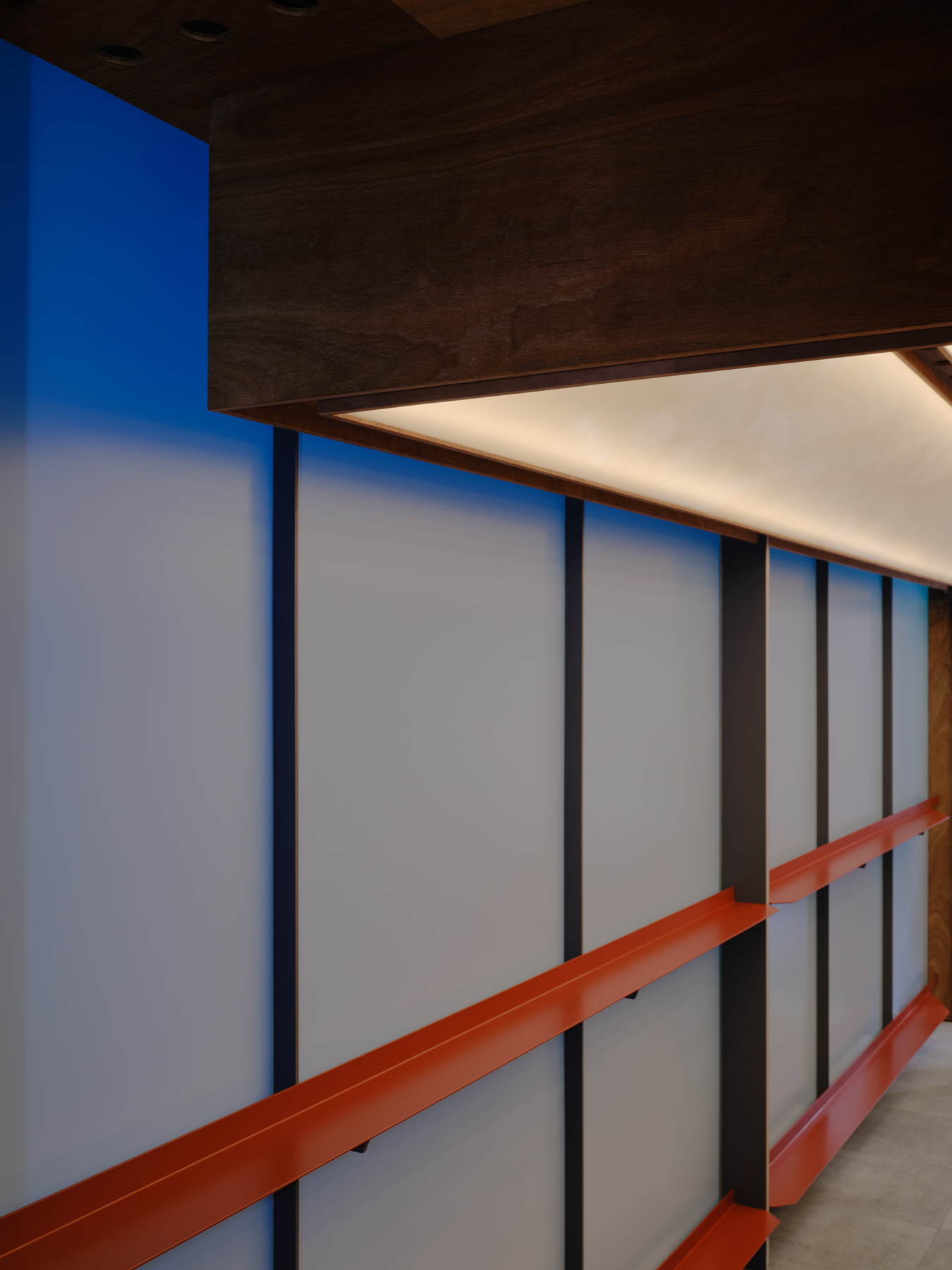 Palace Coffee by KKAP — Interior passage framed through floor-to-ceiling glazing with translucent infill panels.