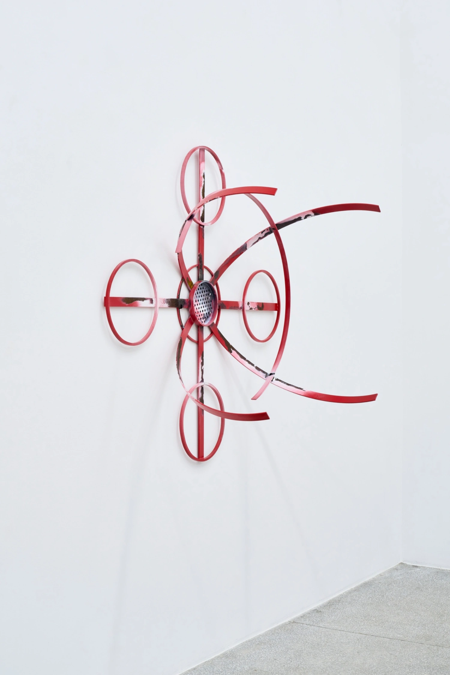 Swarm / Rój by Zuza Golinska at Piktogram — A wall-mounted sculptural form constructed from pink-red wire elements arranged in a symmetrical, three-dimensional composition.