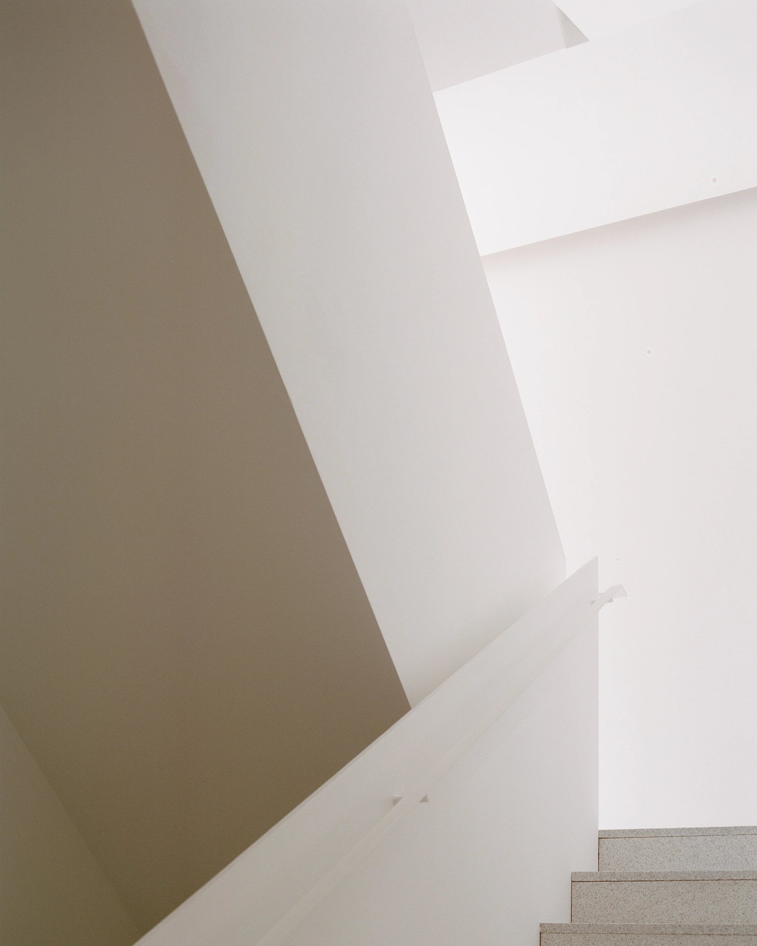 K-Auction Exhibition Hall Sinsa by min_workshop + 3ab — A staircase threshold in the K-Auction Exhibition Hall reveals the spatial logic of min_workshop's design through layered geometric planes.
