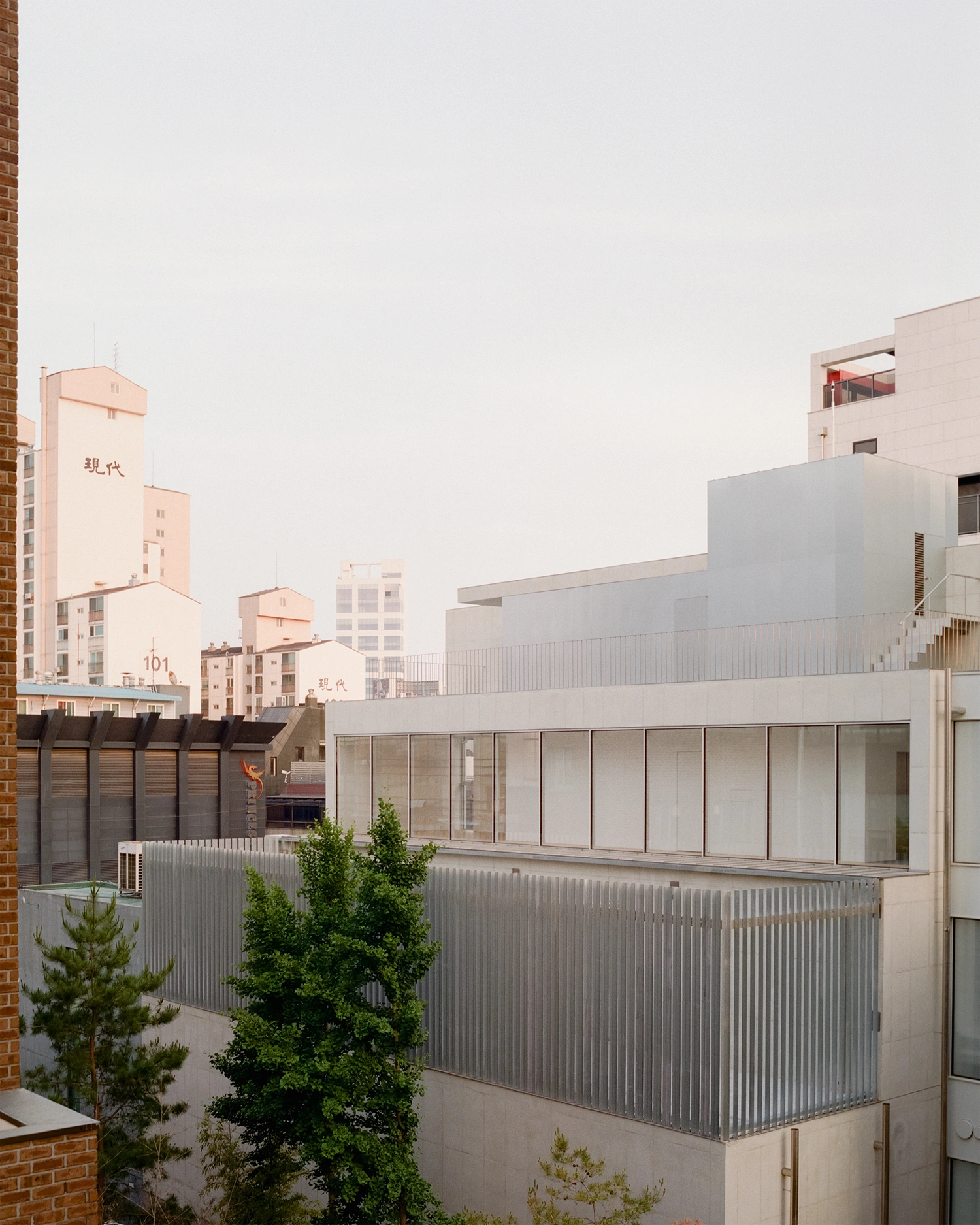 K-Auction Exhibition Hall Sinsa by min_workshop + 3ab — K-Auction's exhibition hall presents a restrained facade composition in Seoul's dense urban context.