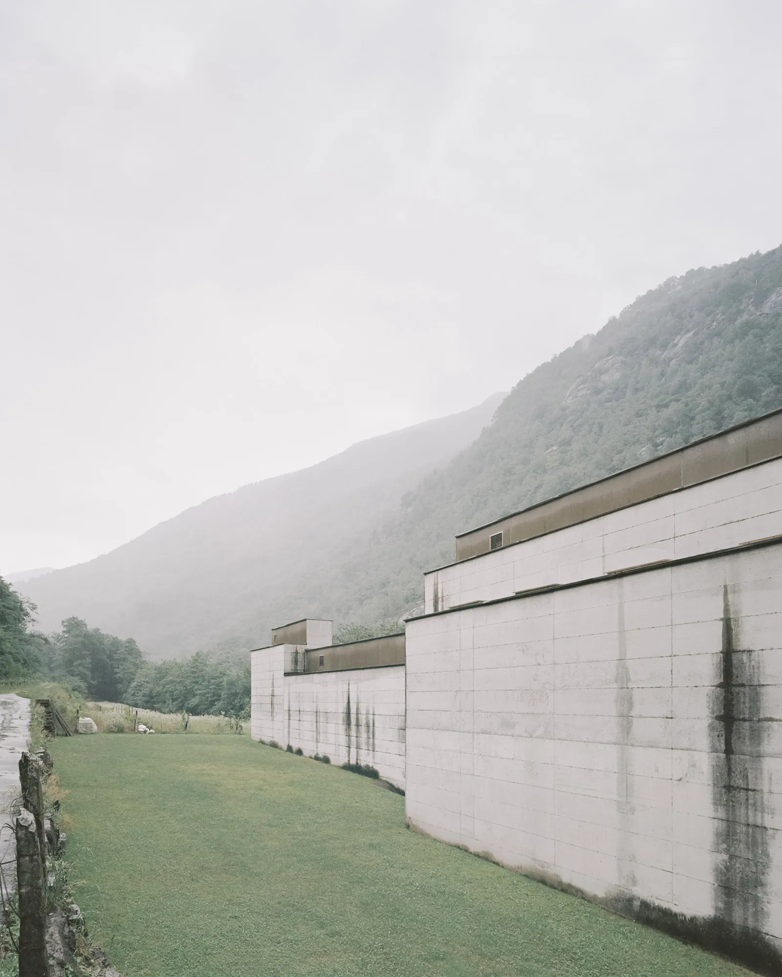 La Congiunta Museum by Peter Märkli — The museum's exterior presents a stepped concrete facade with board-formed surfaces showing distinct wooden formwork impressions.