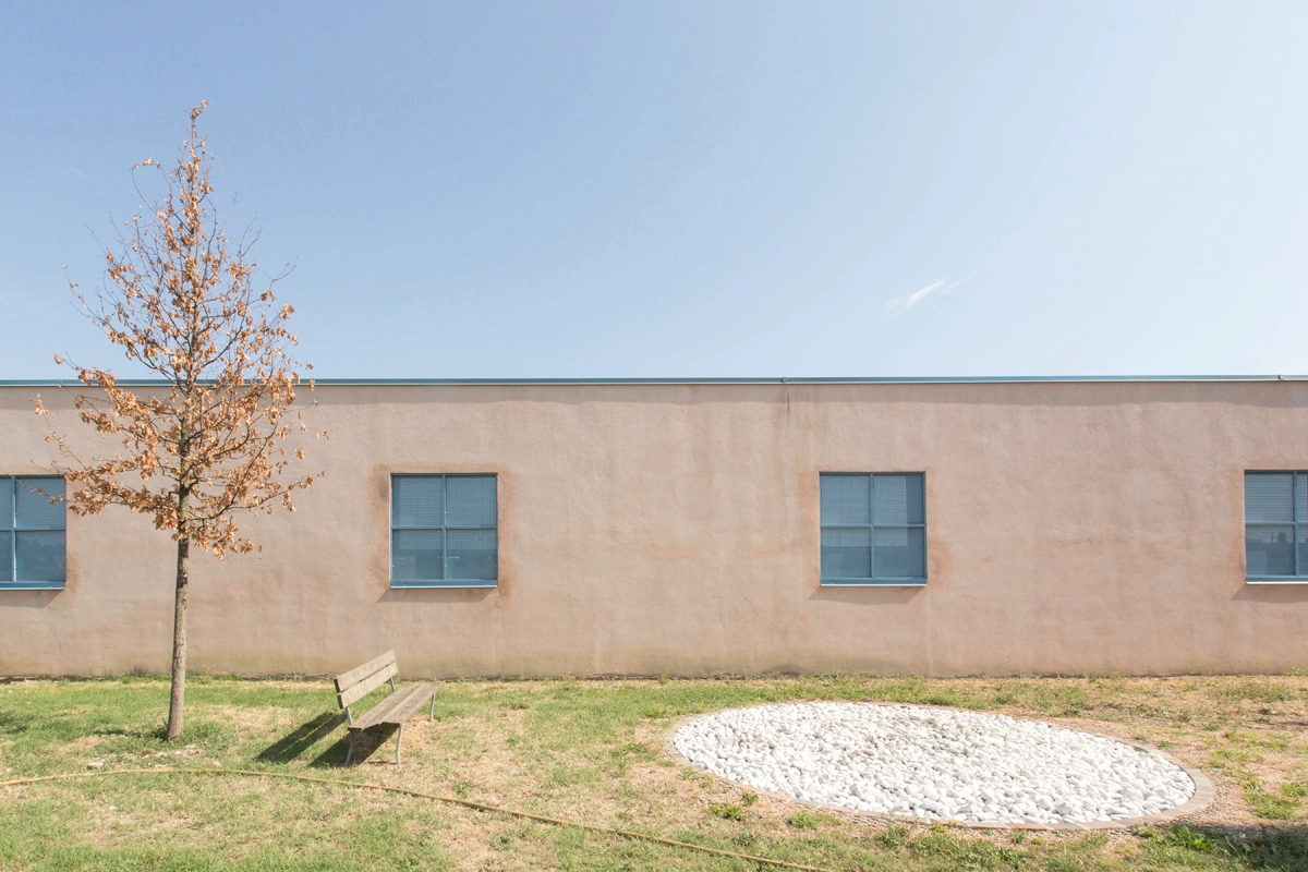 San Cataldo Cemetery by Aldo Rossi — This view of Aldo Rossi's San Cataldo Cemetery isolates a single facade section, revealing the terracotta brick surface and regular grid of square window...