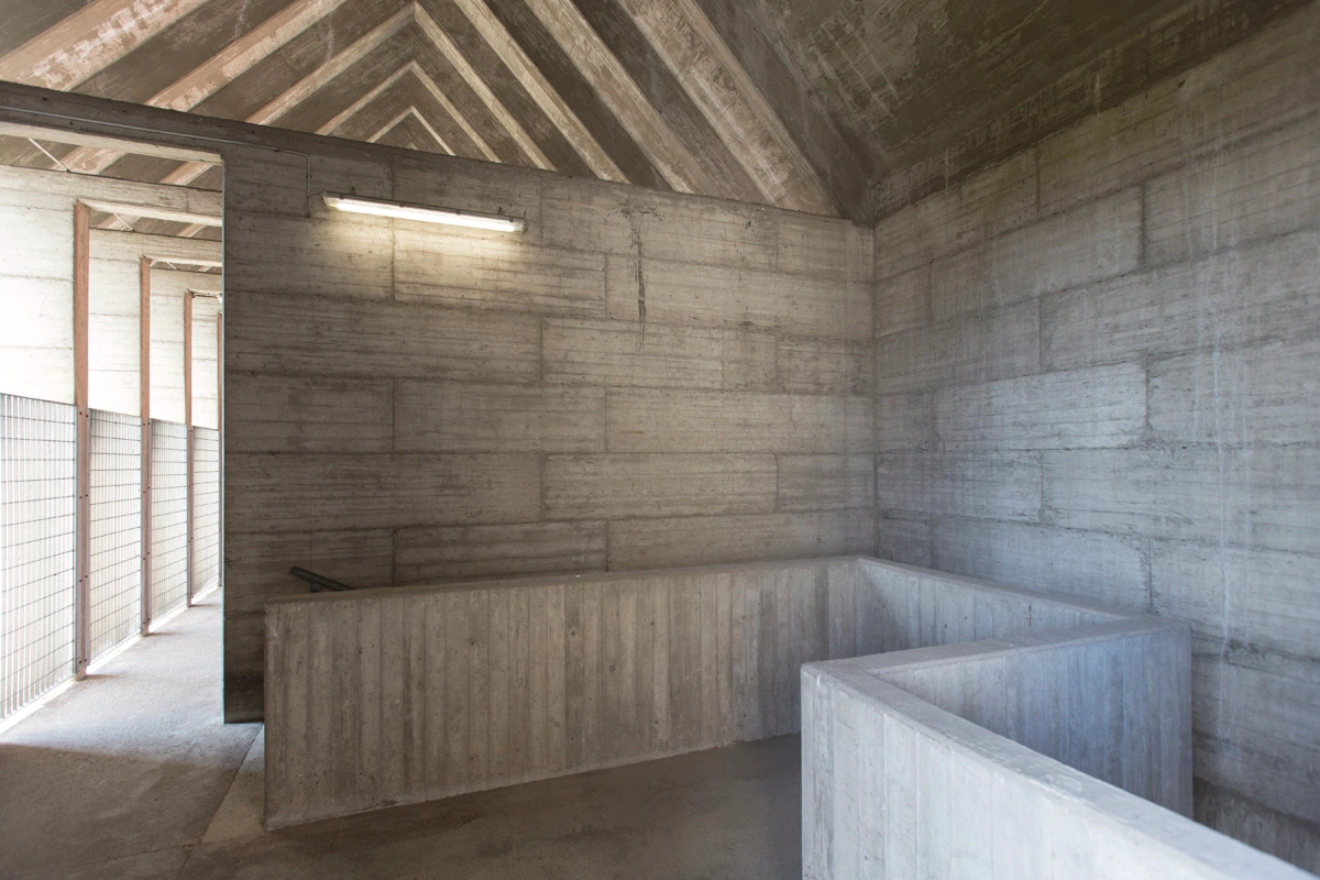San Cataldo Cemetery by Aldo Rossi — Interior view of San Cataldo Cemetery's columned hall, revealing the project's skeletal concrete construction.