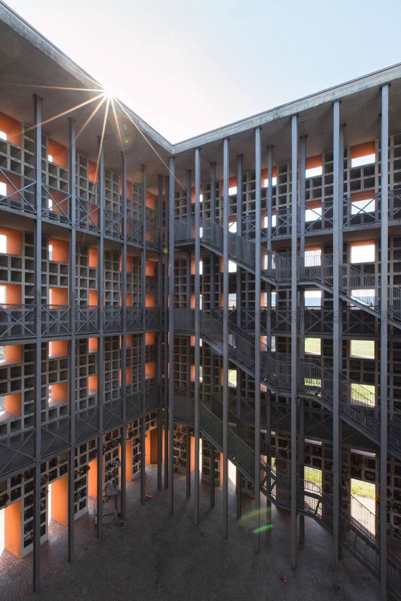 San Cataldo Cemetery by Aldo Rossi — Laurian Ghinitoiu's photograph captures the interior courtyard of Rossi's San Cataldo Cemetery, framing a grid composition of stacked terracotta brick volumes.