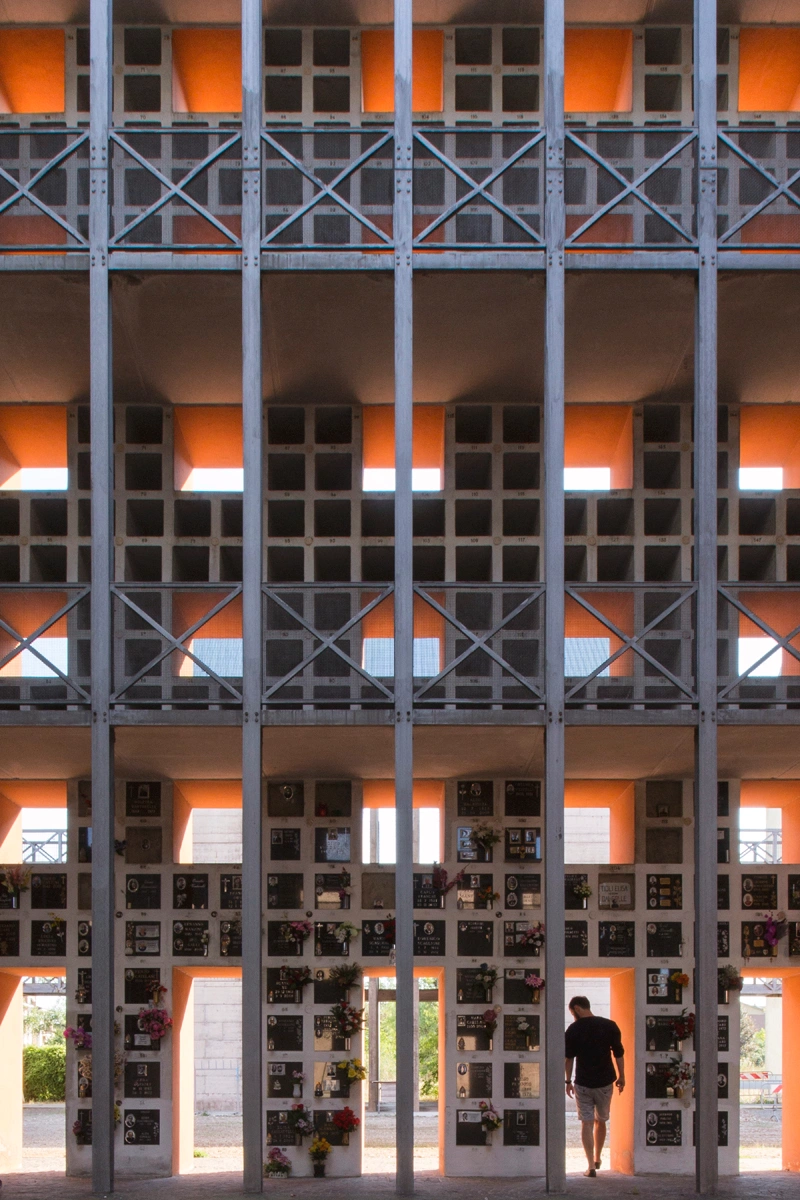 San Cataldo Cemetery by Aldo Rossi — Ground-level perspective of San Cataldo Cemetery's facade reveals the monumental grid system in direct confrontation.