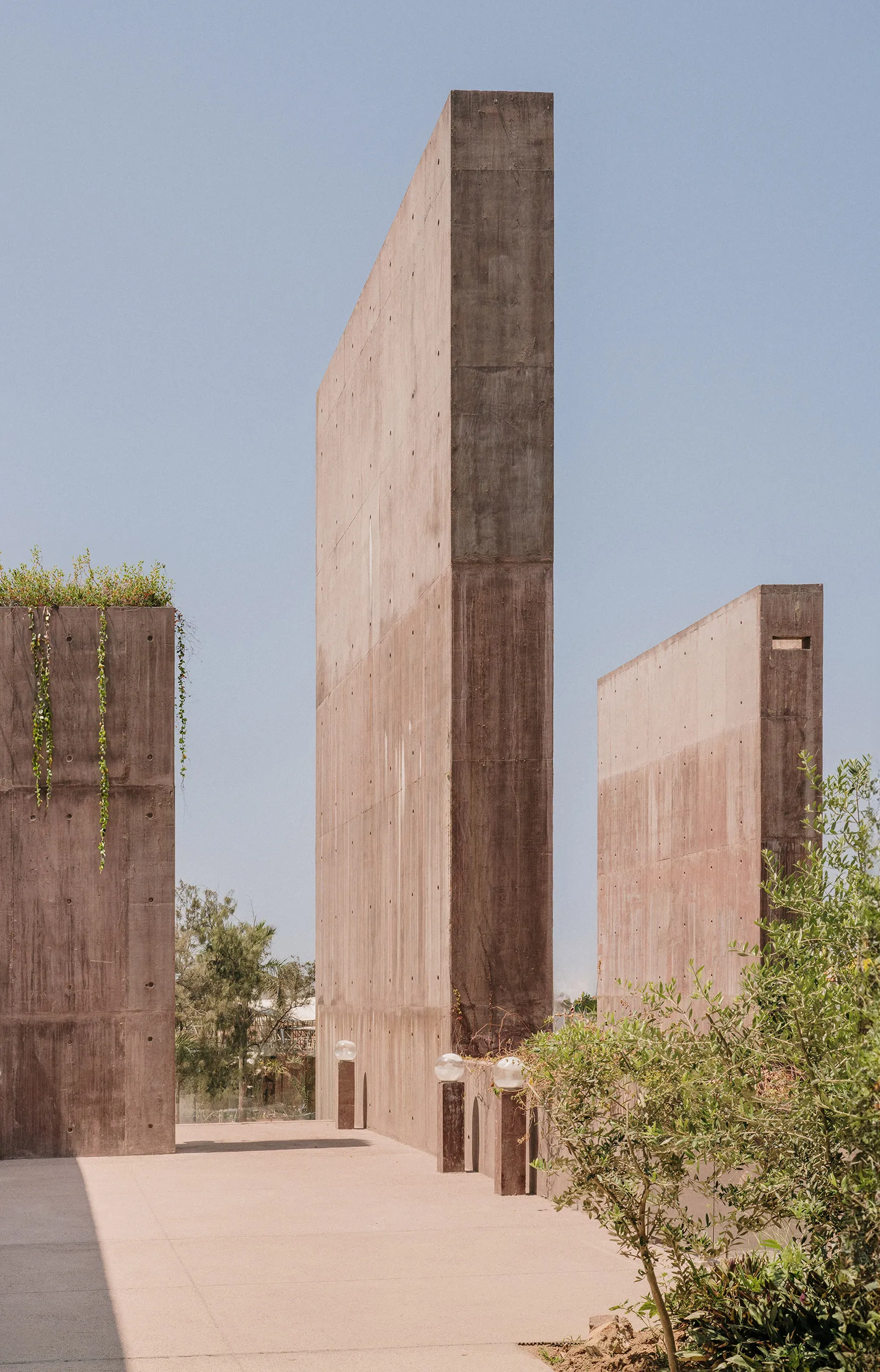Sea of Cortez Research Center by Tatiana Bilbao — Three monolithic concrete towers rise from a minimal desert plaza, their board-formed surfaces displaying horizontal striations and weathered pigmentation...
