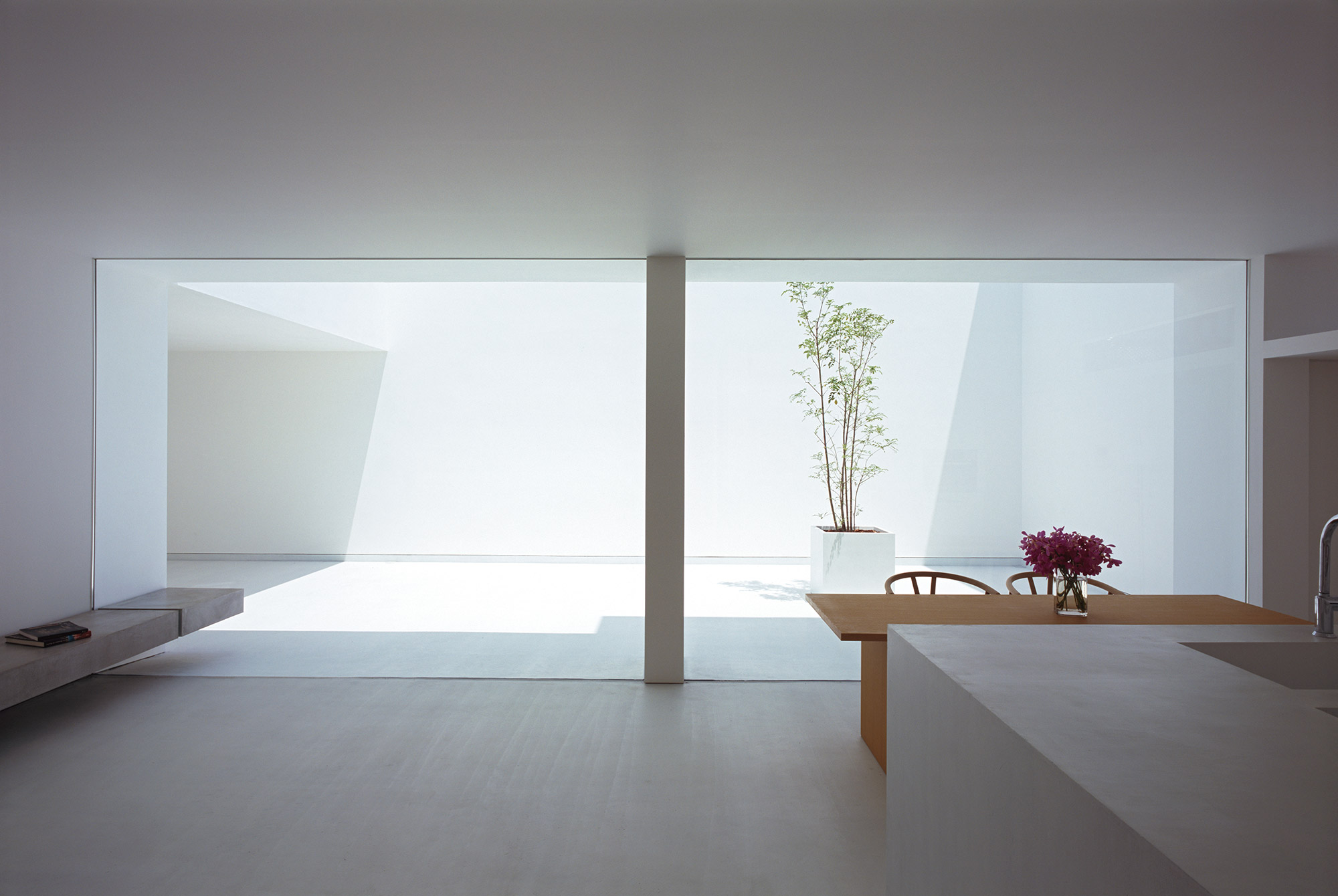 White Cave House by Takuro Yamamoto — Interior view from the recessed void of White Cave House, revealing the spatial interstice at the heart of Yamamoto's design.