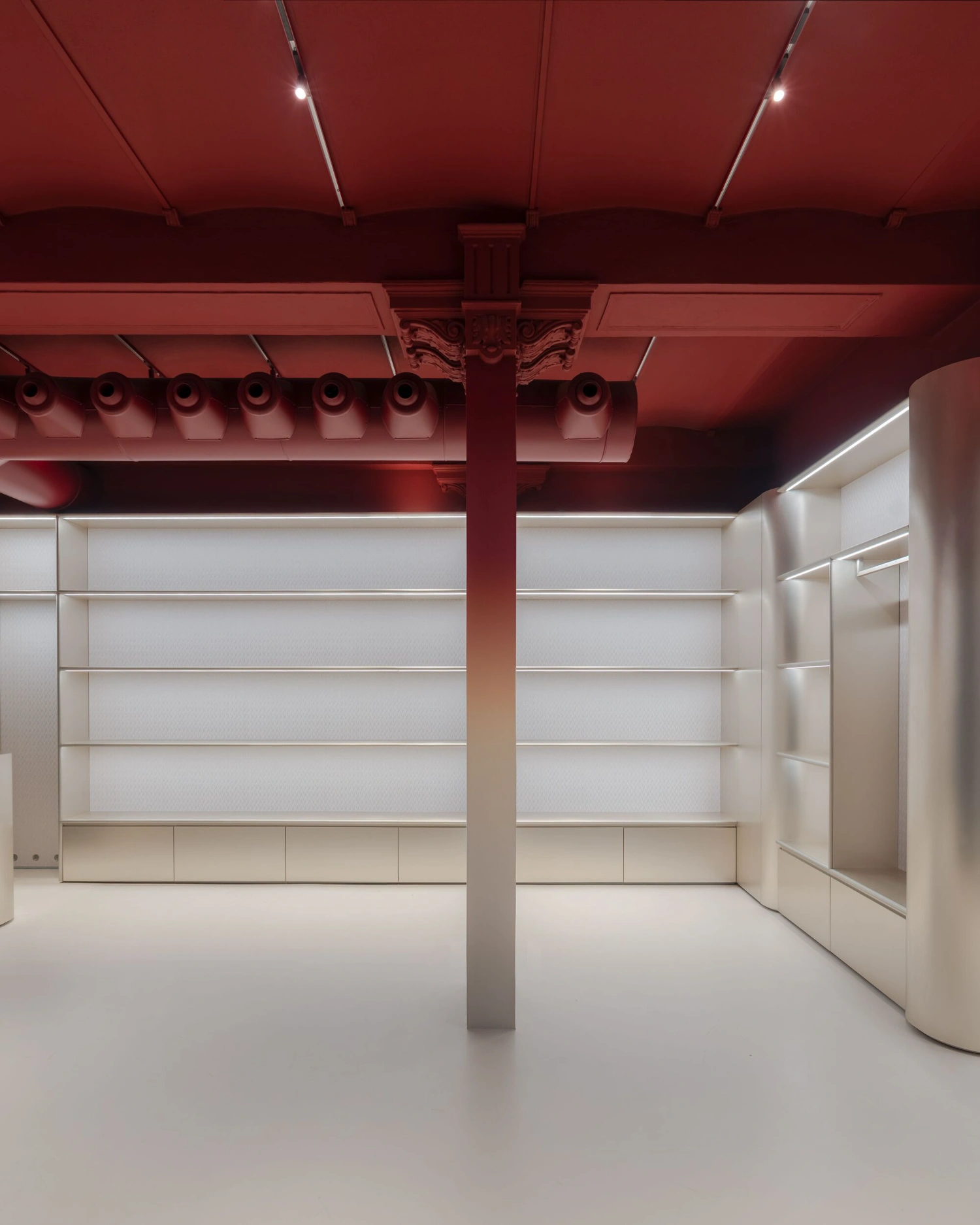 Missoni Home Boutique (Showroom) by Lit Studio — The showroom interior presents a studied symmetry anchored by a tapered neutral column bisecting the space.