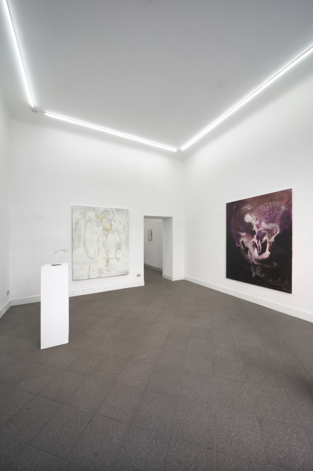 Opacity As A Healing Space by Szilvia Bolla Lorenzo Conforti at Limbo Contemporary — The gallery interior presents a minimalist exhibition space with linear LED ceiling fixtures creating a V-shaped pattern of white light.
