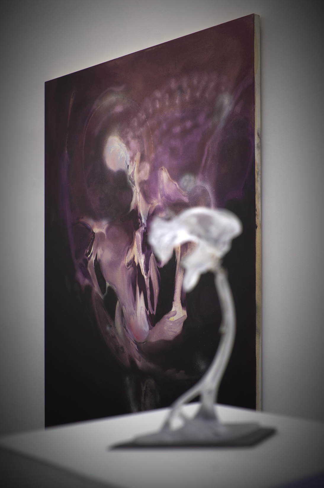 Opacity As A Healing Space by Szilvia Bolla Lorenzo Conforti at Limbo Contemporary — A resin sculptural form dominates the gallery wall, its surface rendered in graduated tones from mauve to deep purple-grey.