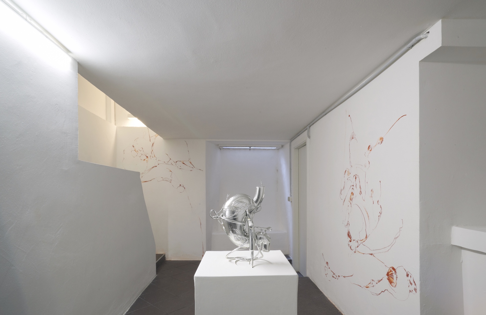 Opacity As A Healing Space by Szilvia Bolla Lorenzo Conforti at Limbo Contemporary — A corridor gallery displays a singular resin sculpture mounted on a white plinth, its surface exhibiting undulating biomorphic curves with a gradient shift...