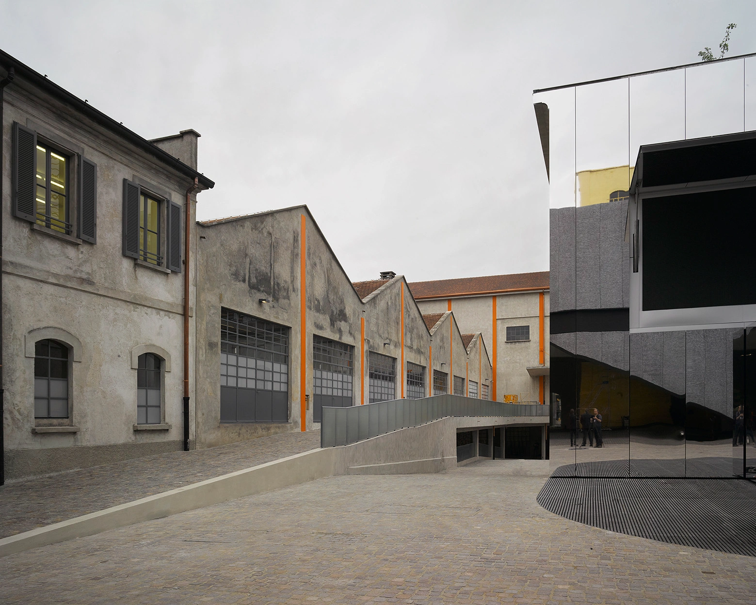 Fondazione Prada by OMA — The courtyard reveals OMA's strategy of spatial fragmentation through material contrast and architectural layering.