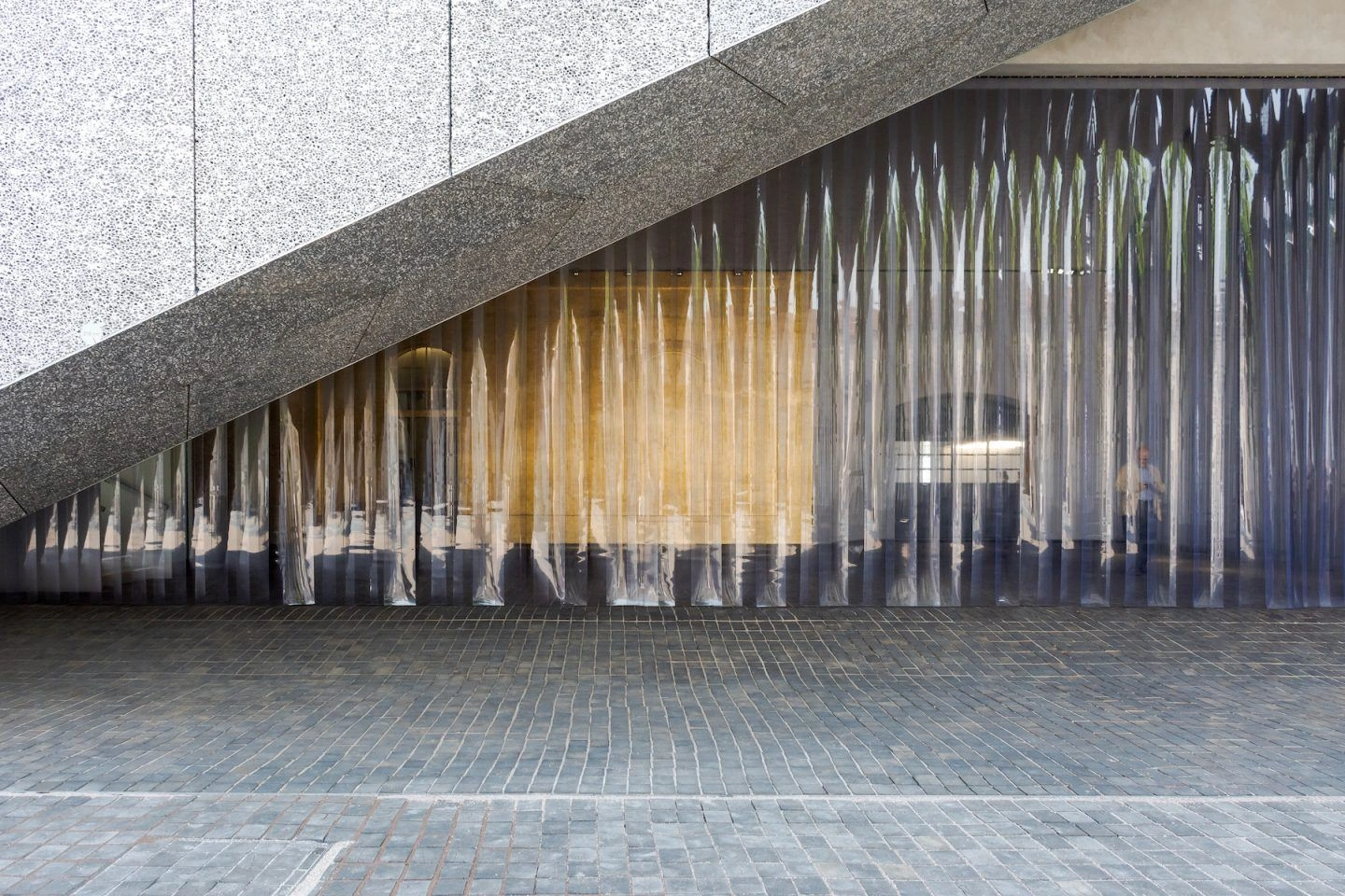Fondazione Prada by OMA — A courtyard view of Fondazione Prada's fragmented complex, captured from beneath a dark-rendered diagonal soffit.
