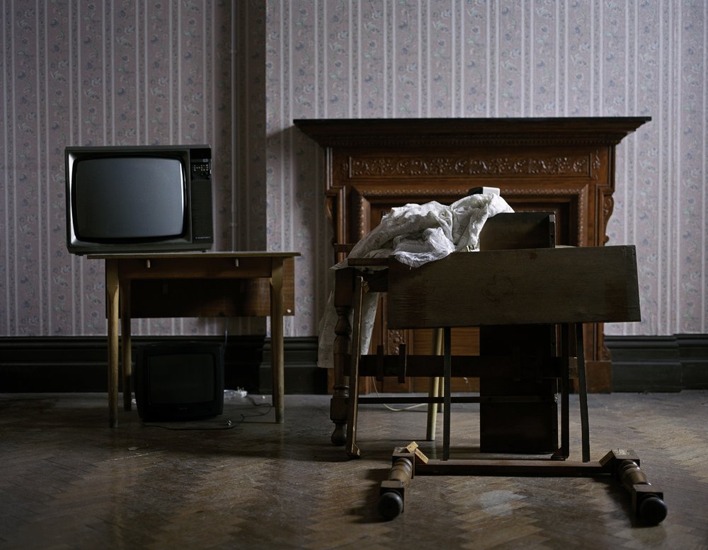 After Magdalene by Ethna Rose O'Regan — A sparse institutional interior documents the aftermath of human habitation.