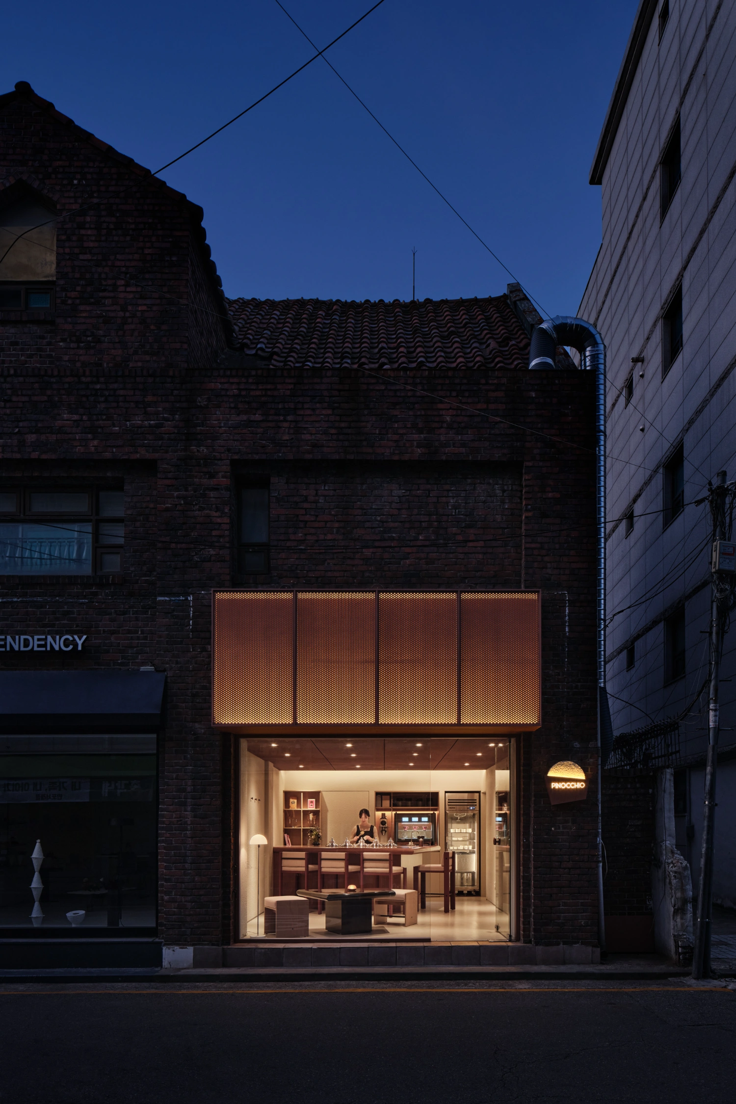 PINOCCHIO Gelato + Coffee Shop by WARP AND WOOF — A pocket-sized gelato and coffee shop occupies a narrow storefront within a historic brick building in Seoul.